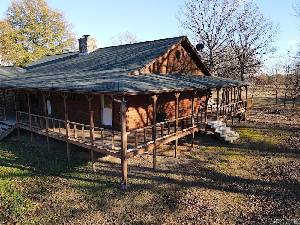 What a marvelous dual-purpose property in the heart of the Ozarks. Decades of care, love, work and thought have gone into this unique and special land. This place is loaded with features and amenities that really separate it from the pack. Bordering the gravel county road, the access is no issue with a wonderful, gated entrance and beautiful private drive to the log home. This home has been maintained wonderfully and is filled with charm, rustic touches, and a split floor plan. The main home also sports a massive wrap-around 8’ covered porch to sit and enjoy the scenery from any angle. The large master suite has a private exit to the east for excellent sunrise views over a great pond. This wonderful space offers a walk-in shower, garden soaker tub, plenty of closet space, and a double vanity. The great room is a showstopper for sure, with its massive custom rock fireplace, vaulted ceilings, and knotty pine floors. The kitchen is open to the dining room and offers a huge island, wall oven, electric cooktop, and plenty of cabinet space. The second bedroom is separated, with access to the second bathroom for the ultimate private experience.