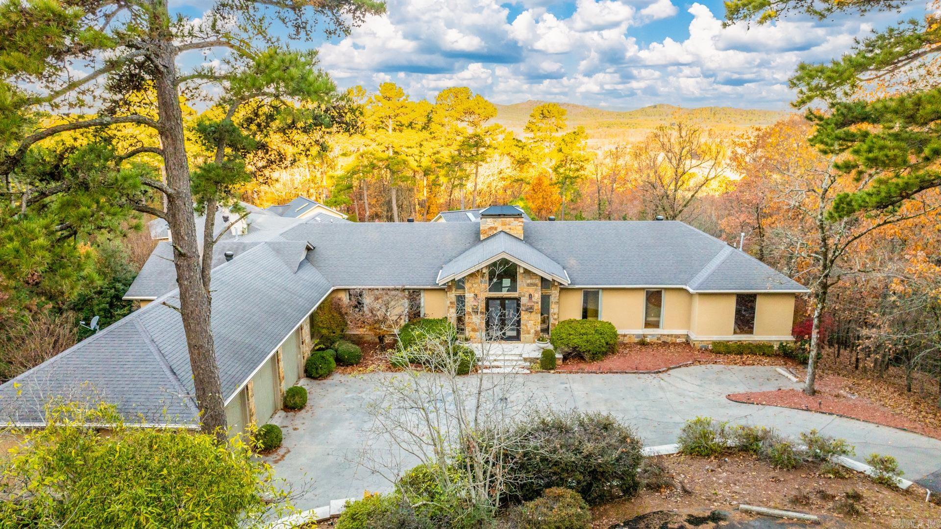 Exquisite 1-Level entertainer’s dream on 6 gated acres in Beau Vue, w/ pool, veranda, & stunning views. Pella double doors open to impressive vaulted grand entry w/ large living: flagstone fireplace + spacious box-ceiling dining. Skylit kitchen: breakfast bar, walk-in pantry, +window-wrapped breakfast. Outside: enjoy your pool, courtyard that was featured in Arkansas Times, +2 buildings: a skylit pool house w/ wet bar +bonus spa house w/ oven, beverage cooler, & walk-in shower. Private primary includes hearth sitting, updated bath, dual closets, and veranda access. Don’t miss office, guest suite balcony, 7-car garage, storm shelter, and backup generator.