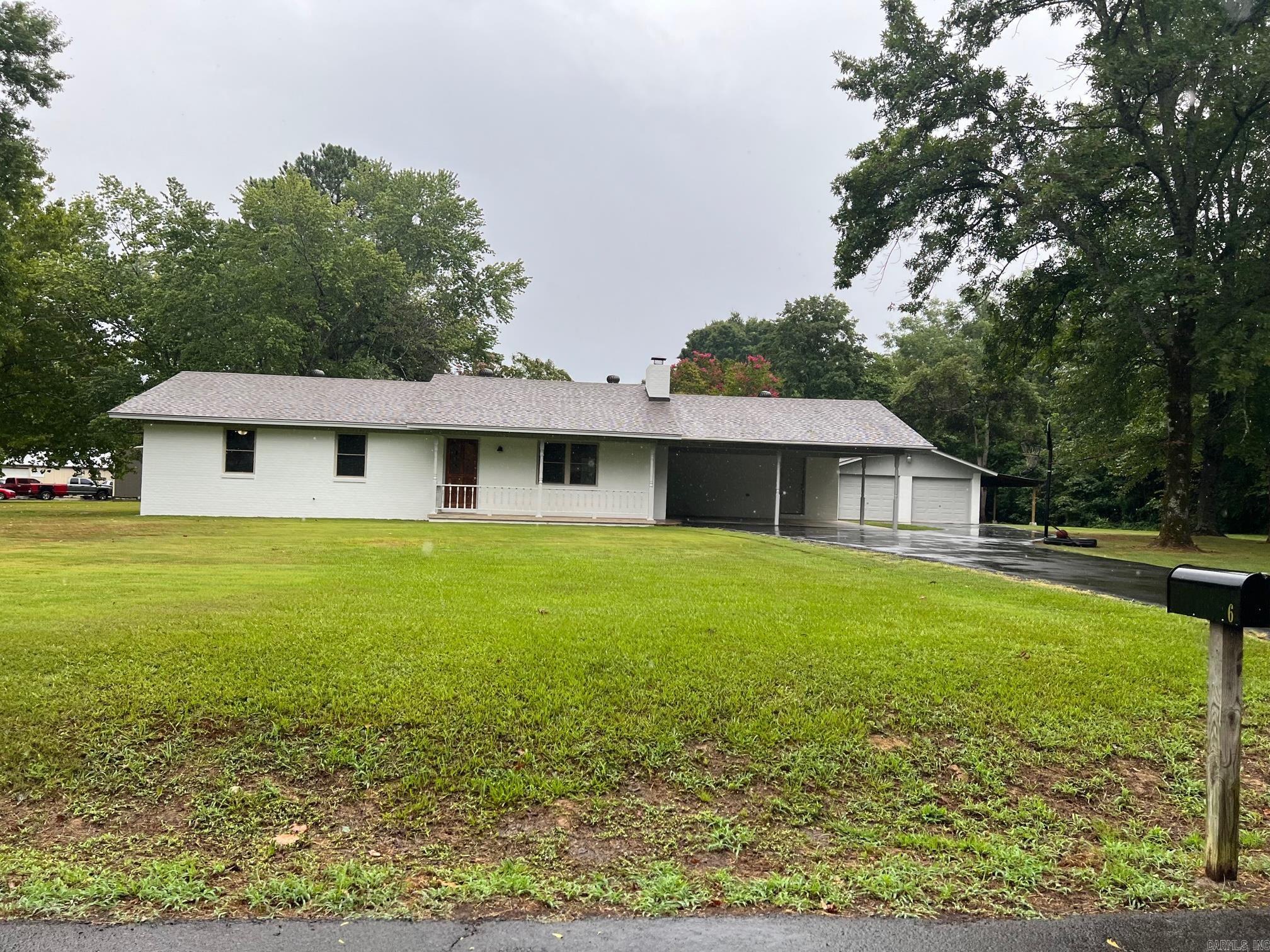 Updated three bedroom two bath brick home sitting on 2 acres. House has just been updated. New Roof, painted exterior brick, new interior paint, newer vinyl windows and the floors have just been re sealed. House has a 2 car carport and a detached 2 car garage/workshop. Shop is painted to match the house. Call today for more information.