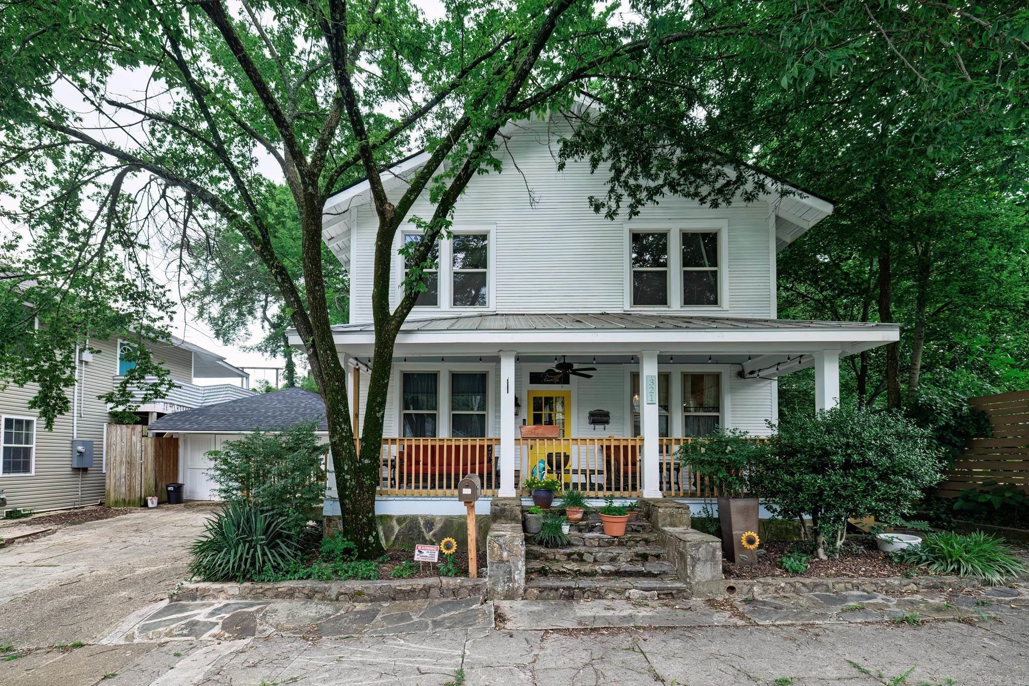 Located in the heart of historic downtown Hot Springs, Arkansas, this charming three-bedroom, two-bath home blends timeless character with modern updates. Built in 1940, the home showcases beautiful original wood floors that flow throughout the space, adding warmth and classic appeal. The inviting living area features charming 12 ft ceilings that enhance the home's unique architectural style. The updated kitchen offers modern functionality while maintaining the home's historic charm, making it perfect for everyday living or entertaining. Step outside to enjoy the beautifully maintained front porch or retreat to the peaceful backyard, complete with a screened-in sitting area, greenery, and more. Whether you're looking for a permanent residence or a weekend getaway, this home offers a rare opportunity to own a piece of Hot Springs history with all the comforts of today.