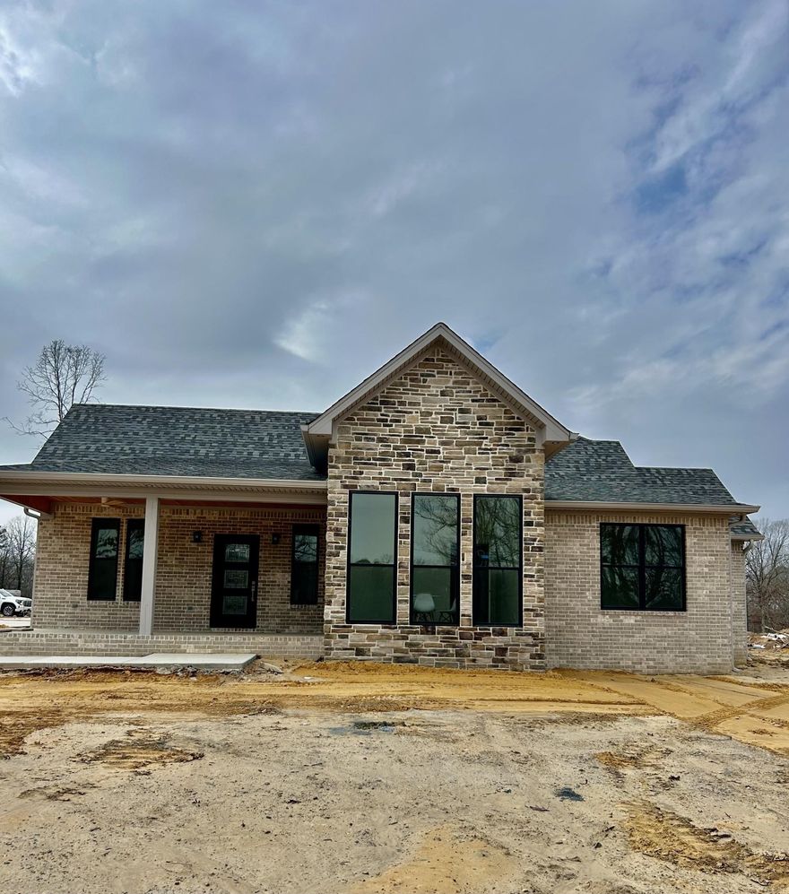 Amazing custom designed Modern Craftsman home sitting on over 1 acre with beautiful views of 2 lakes.  Home features 3-4 bedrooms, one can be used as an office, and 2 1/2 baths.  Open floorplan with a large Family room and Gourmet Kitchen with an 8-foot breakfast bar and formal dining room, which all have 12-foot ceilings and canned lighting. The pantry is equipped with a wine fridge and lots of cabinets.  Master Suite is separate from the rest of the home. It has 2 vanities and large walk-in shower and soaking tub. Huge master closet with lots of built Ins. The front and back patios are great areas for relaxing and soaking in the view.  This home has a tankless water heater and also a generator plug.  All the Bells and Whistles anyone could want are here in this beautiful home!