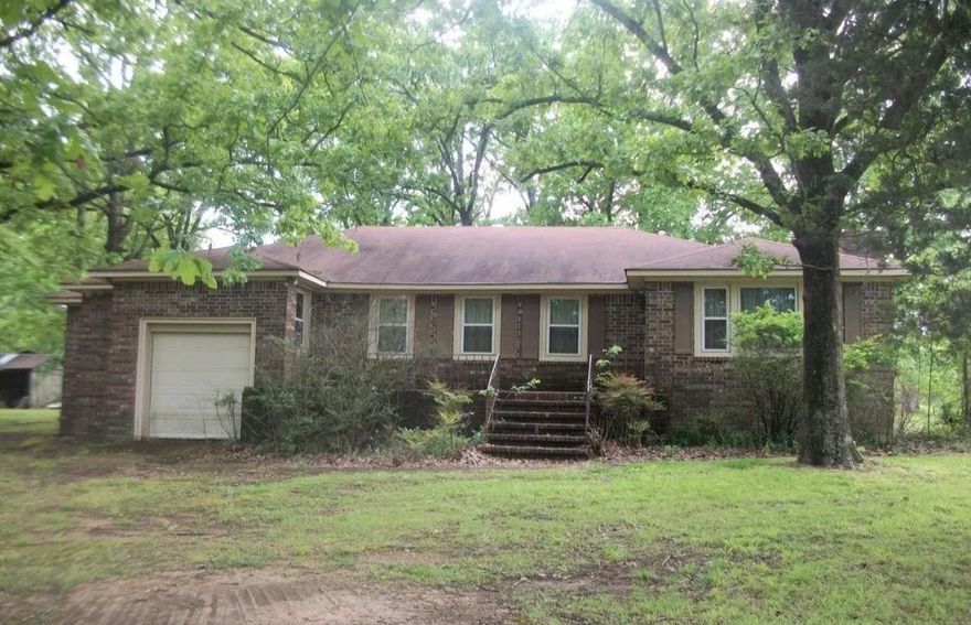 Country Living on a paved road! This property is a lovely home place. A rare find. Mature shade trees, partial fencing, storm cellar, patio, 4 sheds, a barn and a creek all on 24 m/l acres. A 2238 sqft brick home with 4 bedrooms, 2 baths, formal dining room, kitchen with breakfast area, living room and spacious laundry room. The fireplace insert provides cozy heat along with gas heaters. Bedrooms have cedar lined closets, wood floors are covered with carpet with the exception of bathrooms and kitchen. The 24 acres provides approximately 15 acres of pasture, and has been used for horses and cattle. 3 artesian wells are located on property.