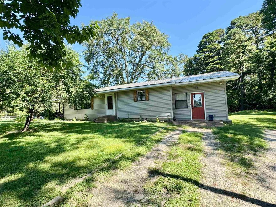 *NEW ROOF & HVAC* Large Home on 20 acres m/l in Calico Rock! This 3 Bedroom, 2 bath home features two living areas, recently remodeled kitchen with granite countertops, and a large master suite with a walk in closet and large windows! There is a bonus room that would make a great mudroom, office, or additional bedroom if needed. Outside the home is a 20x20 shop with electric and lean to for extra storage. There is a barn along with fenced in area for livestock! Fantastic spot to have a hobby farm!  There is also a storm shelter, large patio, fruit trees, and two ponds! Property is located on a paved road within 1 mile of the White River. So many possibilities with this property!