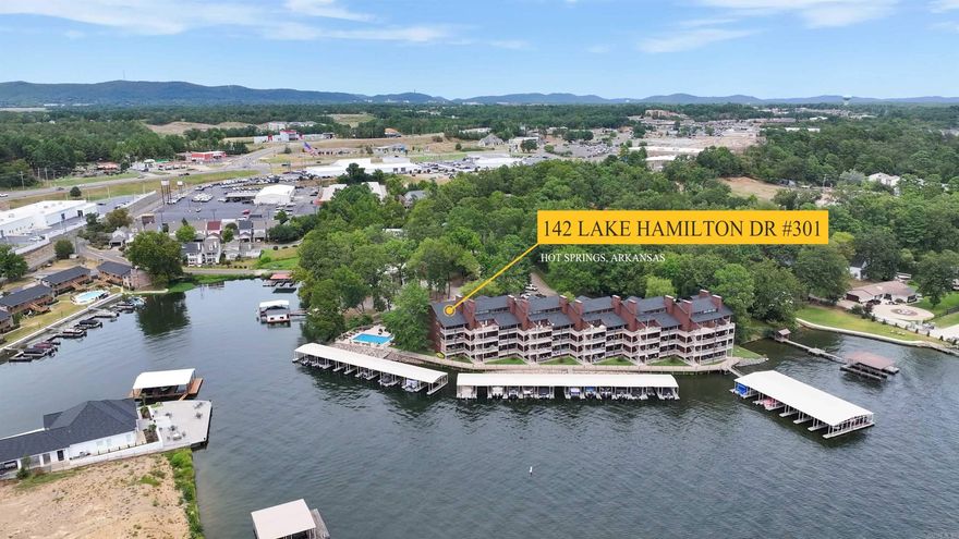 LOCATION, LOCATION, LOCATION!  Lake Hamilton Lake living! Come see this top Fully Furnished, end unit with vaulted ceilings and has an amazing view of the lake!  Remodeled in 2017 with too many updates to mention.  THIS CONDO COMES WITH A COVERED BOAT SLIP AND LIFT!  Never take your boat out of the water year round!  You will also have a prime spot for viewing the Fireworks that the city sets off!  2 covered parking spots also included. Trex decking along the boardwalk added in 2023. Minutes to Oaklawn and downtown for year round entertainment.  Hurry this will not last long.  ***Agents see remarks****