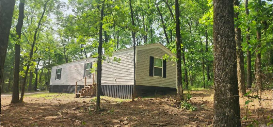Tucked away on the outskirts of Dover, this charming 2 bedroom, 2 bath mobile home offers the perfect blend of comfort, privacy, and country living. Situated on 2.45 acres in a peaceful wooded setting, this 3-year-old home provides a quiet retreat while still being conveniently located. Inside, you’ll find a well-maintained and efficient layout designed for everyday living. A cozy wood stove adds both warmth and backup heating, making the home comfortable year-round. Outside, the property is ready for your rural lifestyle with an outbuilding for storage and a chicken coop already in place—perfect for those looking to enjoy a bit of homesteading. The refrigerator conveys, making this home move-in ready. Whether you're looking for a private getaway, starter home, or downsizing option, this property offers space, functionality, and the tranquility of country living.