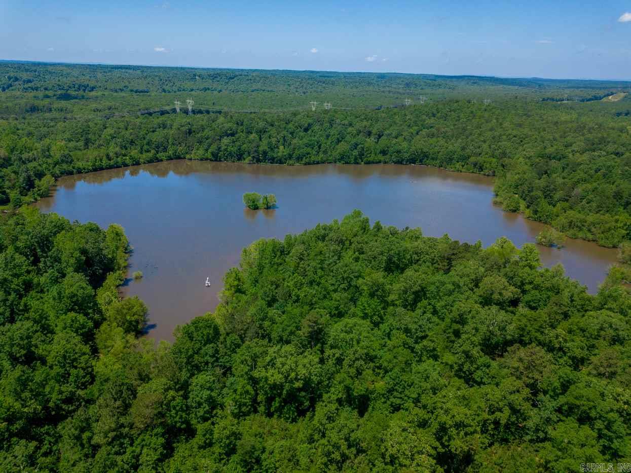 Approx 185 + Acres with a 25 Acre stocked lake. This locations is minutes from I-430 and is ready to be developed or it can be a private oasis for fishing, hunting, camping or ATV recreation.