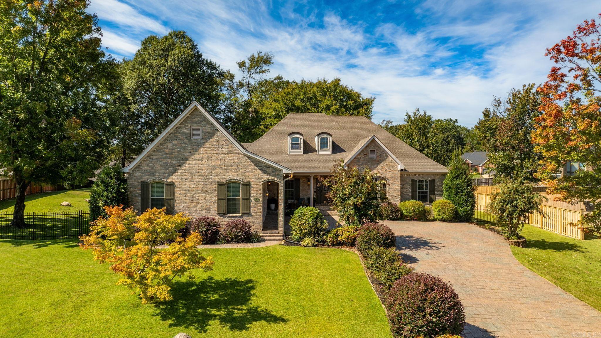 This stunning home in Hurricane Lake Estates blends elegance, comfort, thoughtful updates, and a wonderful lake view. A stamped driveway and manicured landscaping set the tone, while inside, 10-foot ceilings, new LVP floors, a charming stone fireplace with a brand-new mantle, and a formal dining room create an inviting atmosphere for everyday living or entertaining. Designed to live like a one-level, the main floor features a spacious primary suite complete with an office, laundry, and living area, along with three additional bedrooms. Upstairs, a bonus playroom offers flexible space for work or play. The garage and 8x10 shop feature sleek epoxy floors, with recent improvements including a bonus room, new HVAC, hot water heater, and a full house generator. Outdoors, the oversized backyard offers a private retreat with a shaded back porch, mature trees, and a fully fenced yard with wrought iron accents in front and wood fencing along the sides and rear. Truly a rare find you wonāt want to miss!