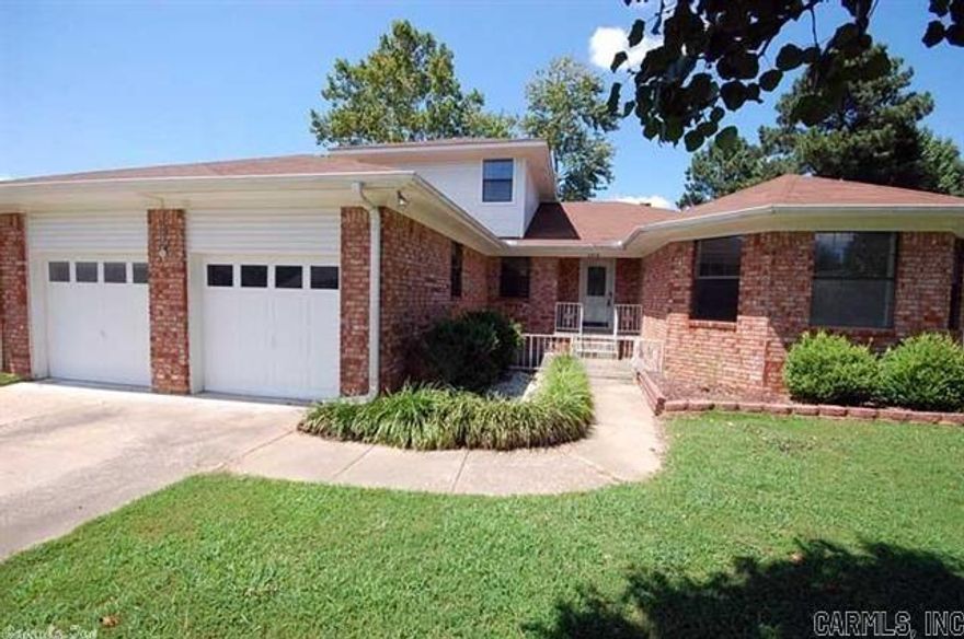 Like new!  This 4 bedroom, 3 full bath home offers 2 living areas, large open kitchen with granite counter tops, new stainless steel appliances, refrigerator stays!  Hand scraped wood flooring in living room & formal dining room.   New carpet, new tile.  Wood burning fireplace in living room.  Master bedroom & 1 guest bedroom downstairs and 2 bedrooms with bath up.  Large deck overlooks fenced backyard.  6" walls for low utilities.