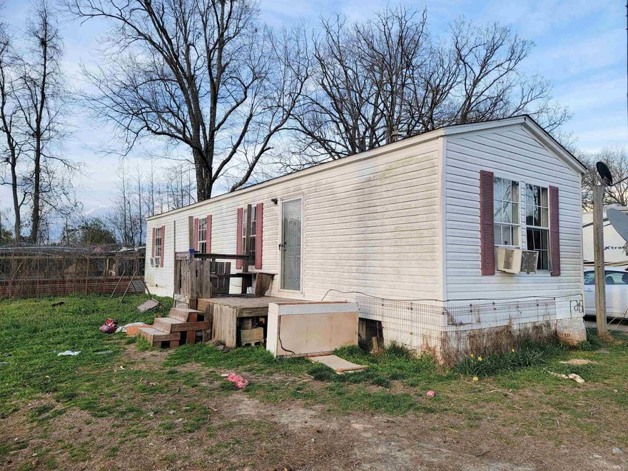 Discover the perfect blend of privacy and opportunity on this expansive 12.5-acre property in beautiful Cove, Arkansas. Whether you are looking for a quiet escape or a site to build your forever home, this land offers a versatile canvas.  The property features a 2-bedroom, 1-bathroom single-wide mobile home. While the home is in need of some TLC, it is fully livable, making it an ideal "landing spot" while you take advantage of the multiple building sites located throughout the acreage.  A small creek meanders along one side of the property, complemented by a small pond (currently overgrown) in the front—perfect for restoration. Rolling terrain with stunning views and plenty of room for livestock, gardens, or outbuildings. The property has 2 outbuildings.