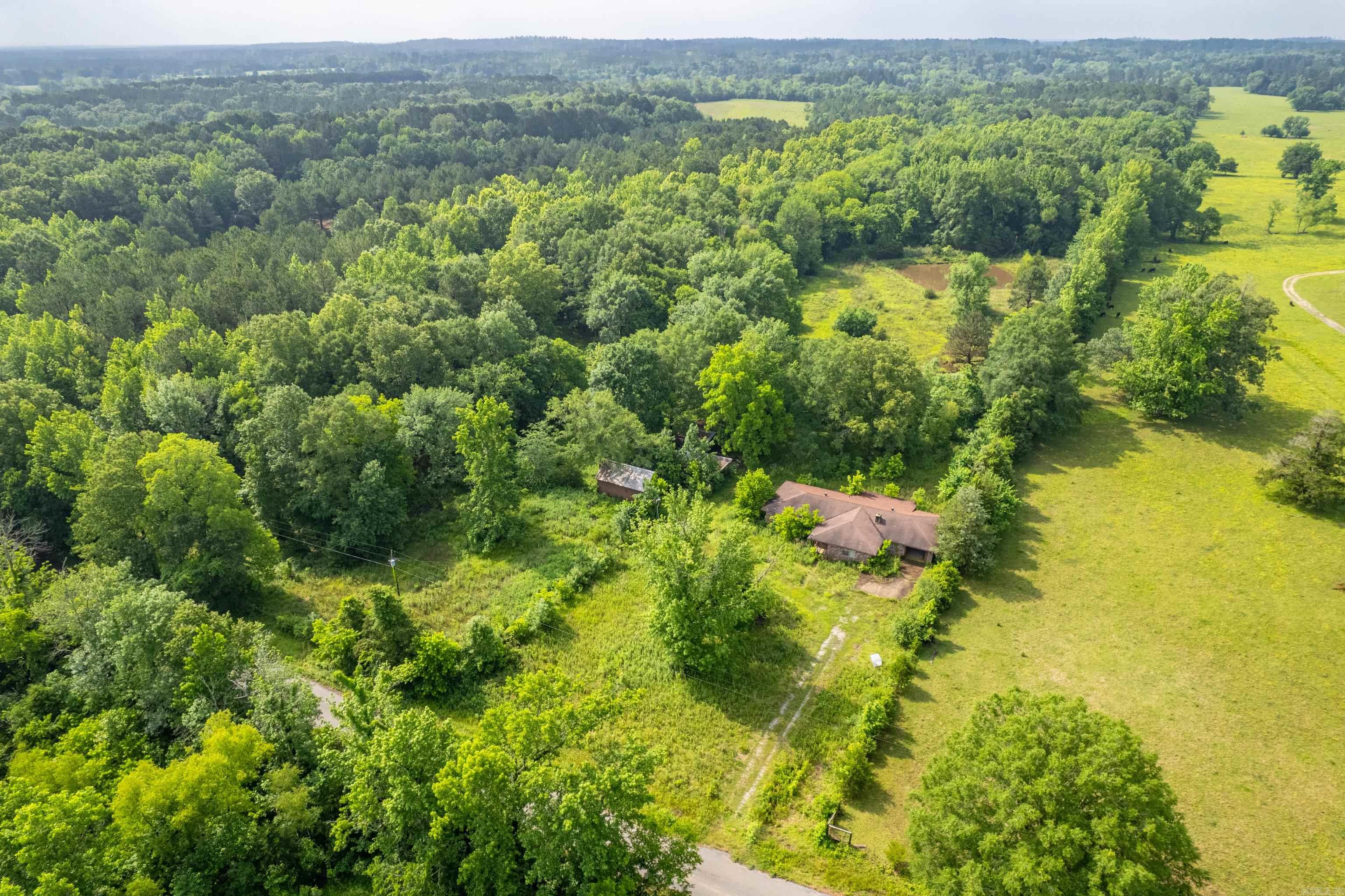 Seeking a project with exceptional potential and lasting rewards? This charming brick residence, situated on approximately 11 acres, offers an ideal canvas for your creative vision. Although the home has remained unoccupied for some time and will require thoughtful restoration, it exudes promise and is set amidst a serene, private landscape. Graced by mature shade trees and a tranquil pond, the property is rich in natural beauty. The brick exterior and accompanying outbuildings further enhance its appeal and provide a sturdy foundation for future enhancements. Whether you're dreaming of a peaceful homestead, a restful weekend escape, or a unique investment opportunity, this property invites you to imagine—and to build—something truly special. Being sold as-is—this is your opportunity to roll up your sleeves, embrace the process, and breathe new life into a place with timeless potential. Agents: see remarks