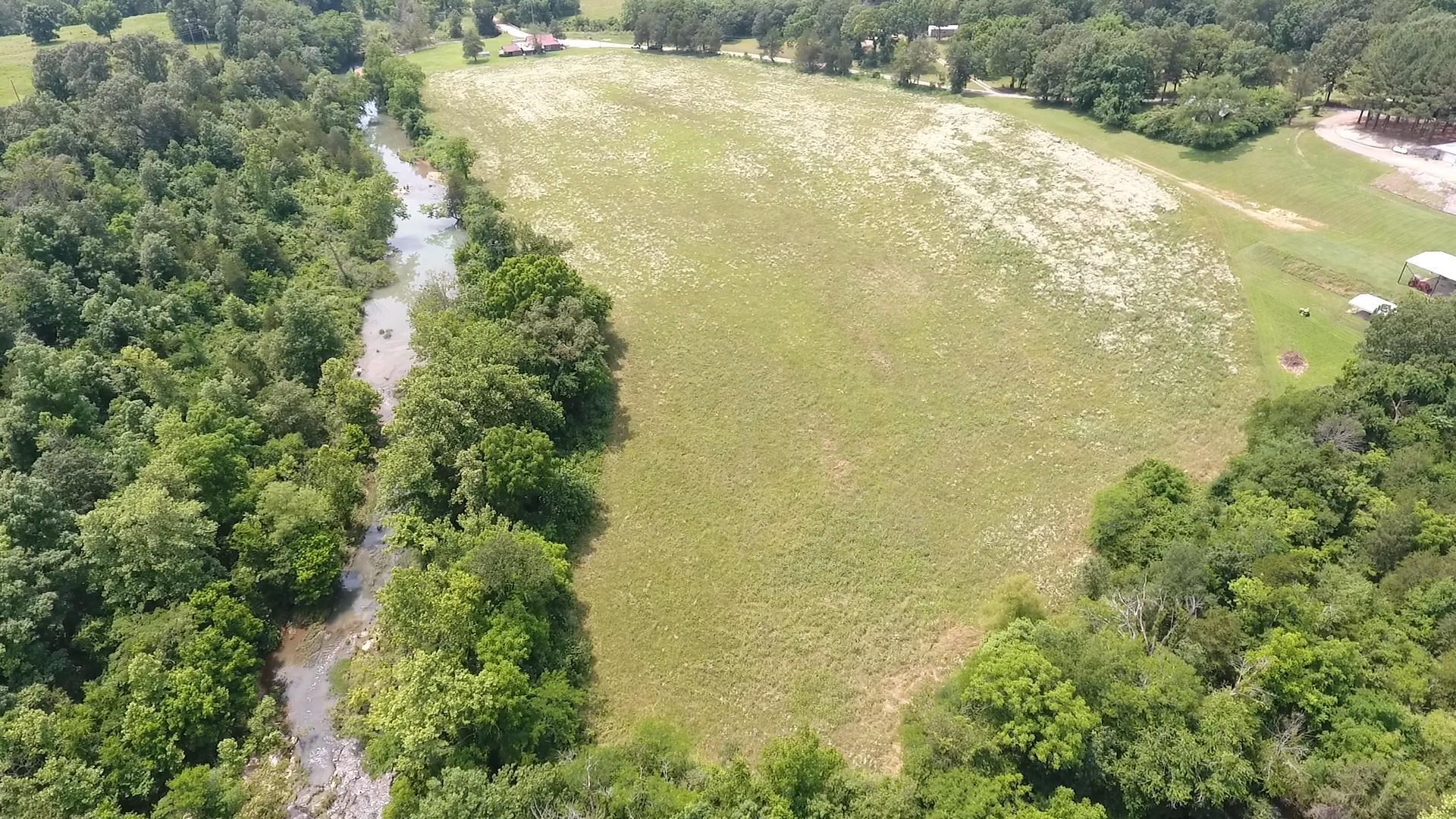 10.6-acre m/l mostly cleared and level property with North Big Creek frontage offers paved road access and city utilities—water, sewer, and electric—available at the property line. With its scenic setting and convenient location, it’s an excellent spot for an RV hookup, recreational use, or part-time living. The land lies within a floodplain, so any long-term plans should be made accordingly, but it presents a great opportunity for camping or seasonal use.