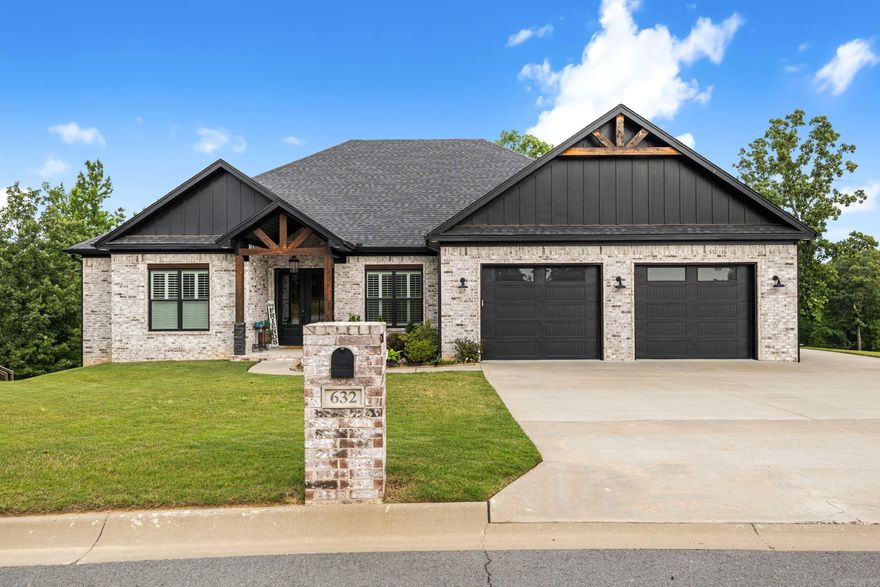 Stunning custom-built home that feels better than new, with thoughtful upgrades and exceptional attention to detail throughout. Beautiful curb appeal, double front doors, and 11' entry ceilings make an impressive first impression. Natural light throughout home is showcased with plantation shutters. Just off the entry, a private office features a gorgeous coffered ceiling, while the open living area offers 12' beamed ceilings and an inviting layout designed for everyday living and entertaining. The kitchen features a gas range, built-in refrigerator, spacious island, quartz countertops, white cabinetry, and ample workspace. The main suite is a true retreat with beamed ceilings, double separate vanities, soaking tub, oversized shower with two shower heads plus rain shower, and an incredible closet that connects to the laundry room. Opposite side offers 3 additional bedrooms, including one ensuite, 2 full baths, and its own zoned HVAC. Enjoy the additional 1/2 bath, screened-in porch with built-in storage and granite counter, expanded deck overlooking the creek, oversized garage, walk-up floored attic, tankless water heater, and finished shop with electricity. This one is special.