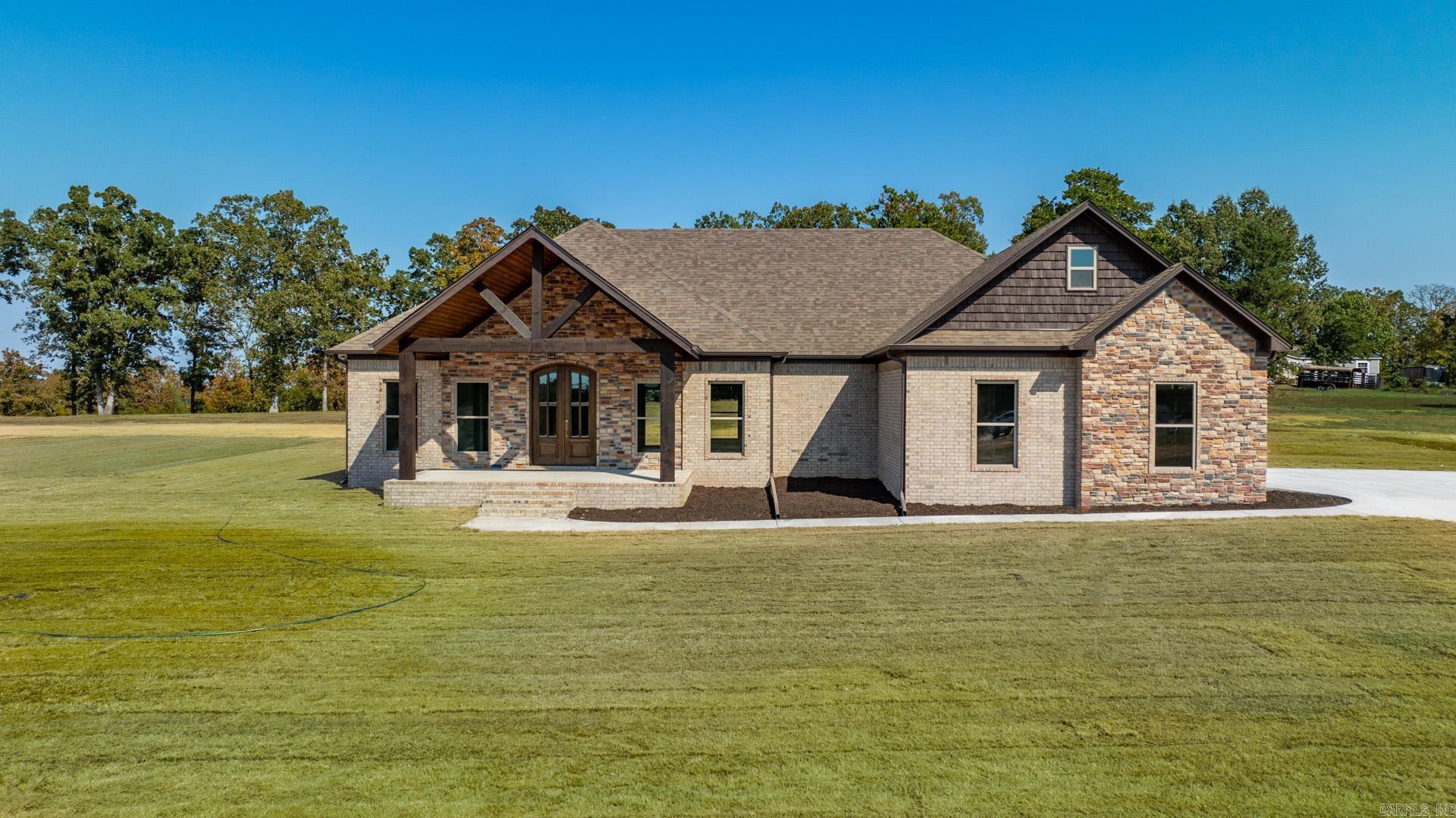 This home has a commanding view of the neighborhood! Enjoy beautiful sunsets from the front porch and lazy evenings on the back porch. Open plan with spacious kitchen and lots of cabinetry. Pantry is hidden behind cabinet doors. Cabinets are painted a soft grey with granite countertops. The fireplace is a focal point in the living room. Guest bedrooms are separate from the primary bedroom. Lockers as you come in from the garage. The laundry leads into the closet which in turn opens to the primary bathroom. So many extra amenities in this home.