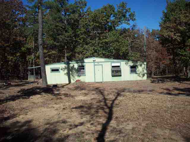 5 acre tract with the minerals conveying, 1 large bedroom, 1 bath, large living area, dining, kitchen combo area, vaulted ceilings in every room, sheetrock walls and ceilings, 2 window air units, 2 propane space heating units, carpet and tile flooring on a concrete slab, fenced back yard for dog, nice large trees on the property, private location for weekend get away or a great place to build a dream home, abundance of deer, wild turkey and a variety of wild life, cabin needs some repairs, sold as is.