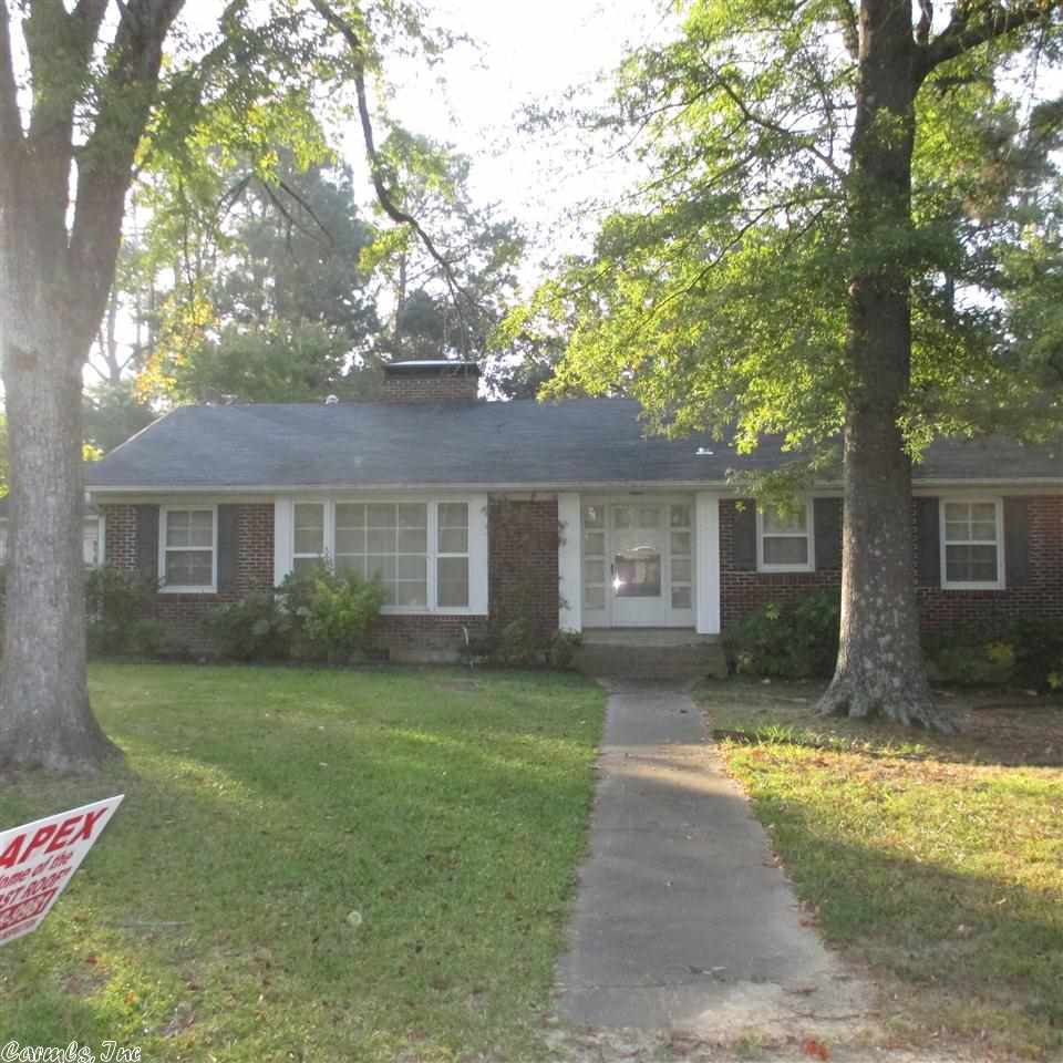 Large brick home on corner lot. Right in town, you could walk to library, bank or stores. This home has 3 large bedrooms, 2 1/2 baths, sunroom, den with kitchenette, that could also be used as guest/inlaw quarters. Great patio area off the back of the home to enjoy your morning coffee. Carport with extra storage. Outside storage building. This home has charm and space for your family. Call today for your personal tour.