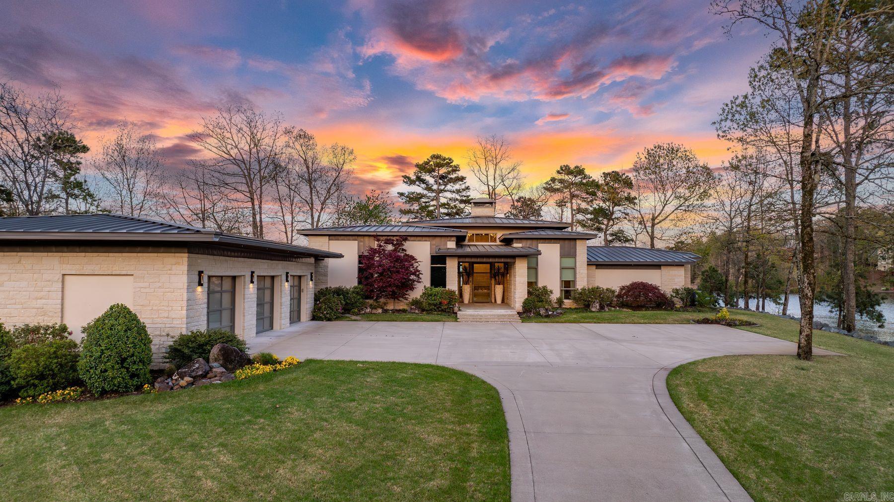 Experience the ultimate in lakeside living with this one-of-a-kind estate on a private peninsula on Lake Balboa in Hot Springs Village. Nearly surrounded by water and mature trees, it offers panoramic views, unmatched privacy, and a retreat-like setting. A long, elegant drive leads to this architectural gem featuring a low-profile roofline, expansive windows, and natural exterior. Inside, enjoy a chef’s kitchen, spa-like baths, and spacious living areas. Outdoors, relax on multiple patios, take in sunsets, or enjoy the covered dock. Professionally landscaped with stone accents and a mix of evergreens and hardwoods. A rare chance to own a luxurious lakefront retreat with sophistication, seclusion, and direct access to one of HSV’s most desirable lakes.