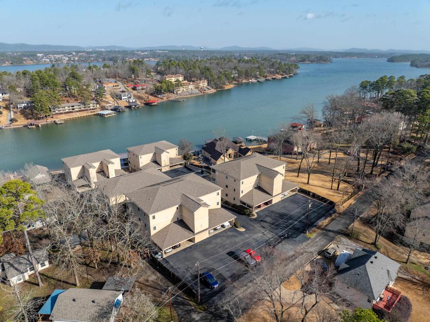 Experience the best of lakefront living at the exclusive Lookout Bay complex in the 7 South area of Lake Hamilton. Step off the elevator and into your private retreat—perfect for relaxing, unwinding, and recharging. Take in stunning lake views from the balcony or soak up the sun by the pool. Conveniently located just minutes from dining, shopping, grocery stores, and health care, this gated community offers both security and comfort. Assigned covered parking is included, and the refrigerator, washer, and dryer convey—making this move-in ready gem a must-see!