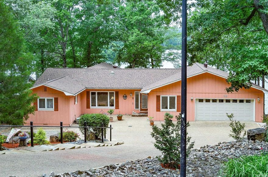 Beautiful 4 bedroom, 3 bath lakefront home on Lake Cortez featuring one of the best views on the lake. This property offers a panoramic sunroom with stunning water views, a spacious grilling porch and entertaining area, updated bathrooms and a gorgeous stone gas fireplace that creates a warm and inviting atmosphere. This home also includes a separate office, ideal  for remote work or a quiet study space, along with golf cart storage and a large lower level workshop/work area providing excellent functionality and storage. An abundance of lush landscaping leads to a double boat dock equipped with lifts that will allow to enjoy all aspects of the lake.This home combines scenic beauty and exceptional outdoor living on one of Lake Cortez's most desirable waterfront settings,