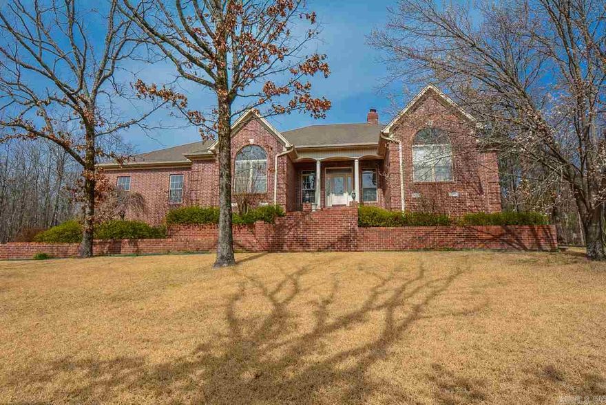 What an entrance! Gorgeous brick work lines the sidewalk and steps to the front door. Beveled glass door into great room 12 ft columns up to the ceilings. Fireplace   by built-ins sunroom overlooks  landscaped yard, large eat-in kitchen with island and pantry. Spacious master suite with jetted tub, walk in shower, separate office space. Lots of storage. Situated on beautiful yard, zoysia grass and plenty of blooming scrubs and trees.