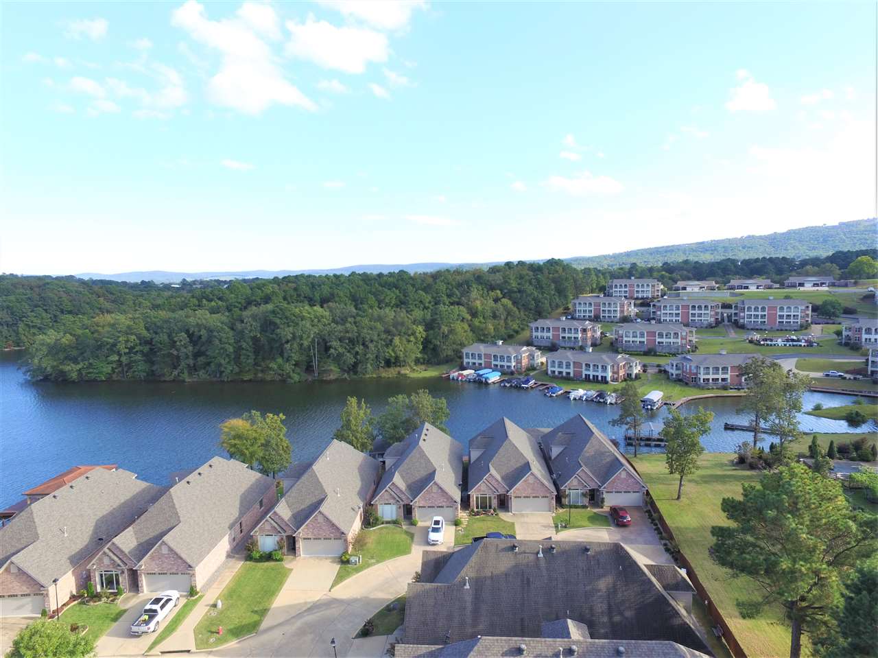 THE BEST OF LAKE LIVING! Enjoy all that Lake Hamilton has to offer in this TOTALLY UPDATED 4 bedroom, 3 bath home right on the water's edge in one of Hot Spring's premier gated lake home communities. New paint, new carpet & new media room completed in 2020. Large, open-concept kitchen, dining, living areas. Master suite with amazing lake views and 2 guest bedrooms with bathroom on main level. 1 bedroom, bathroom, living room/game room & media room upstairs. Covered boat dock with lift and PWC dock. (Cont)
