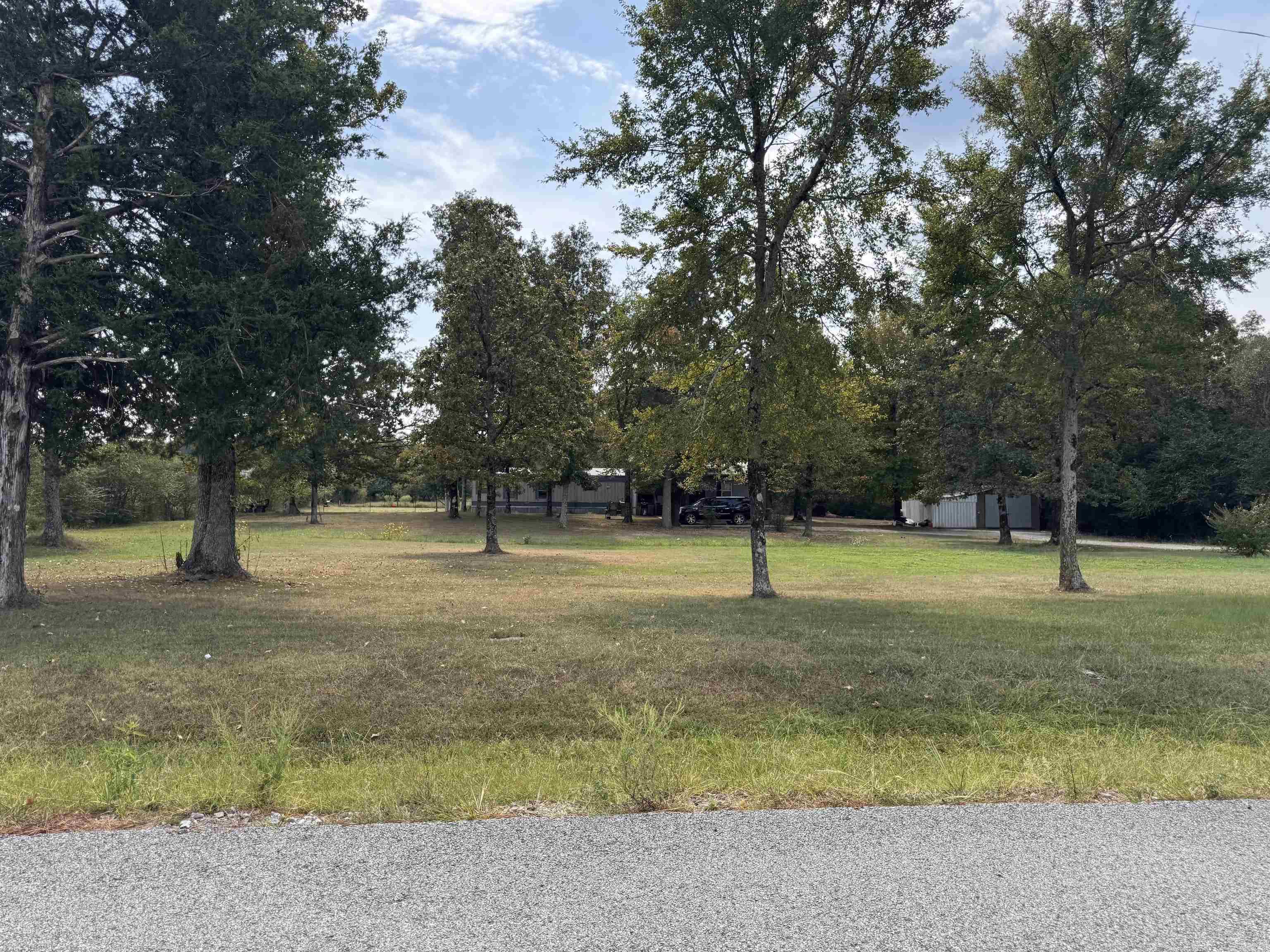 A country feel with pasture and wooded areas surrounding, this 5 acre lot has a home that sits back from the paved road. An added porch and extra room was built on to the original mobile home. The owners suite has a large connected bath with separate tub and shower. There is also shop building with a storm shelter. Lots of wildlife make this a great place for a hunting enthusiast, or room to have a small farm and livestock with a pond. See agent remarks for showing instructions.