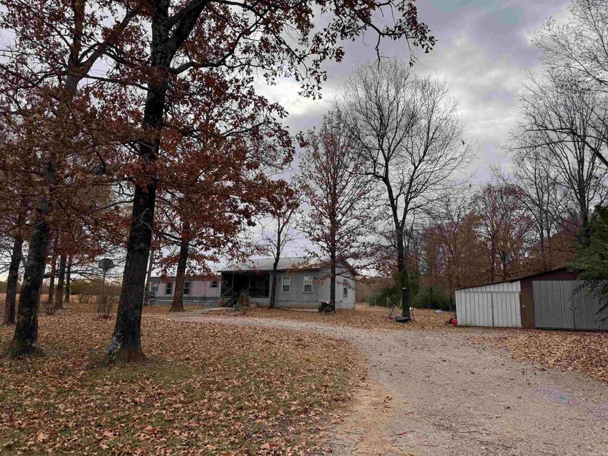 A country feel with pasture and wooded areas surrounding, this 5 acre lot has a home that sits back from the paved road. An added porch and extra room was built on to the original mobile home. The owners suite has a large connected bath with separate tub and shower. There is also shop building with a storm shelter. Lots of wildlife make this a great place for a hunting enthusiast, or room to have a small farm and livestock with a pond. See agent remarks for showing instructions.