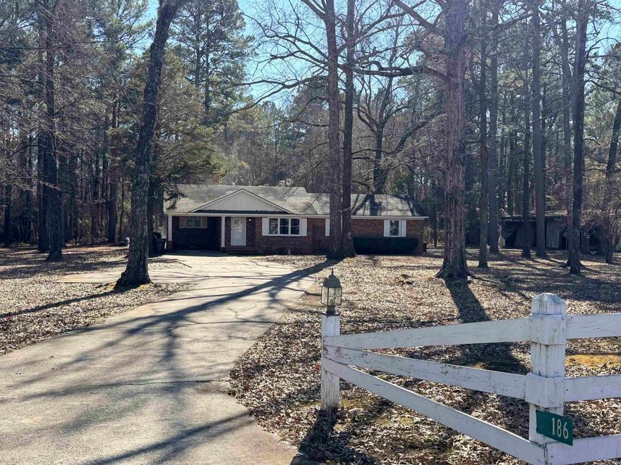 Spacious 4 bedroom / 2 bath home on 7 partially fenced-in acres located just outside Crossett city limits. Beautiful white kitchen with granite countertops & breakfast bar open to living room and formal dining room. Step-down into the office with ample built-ins and space for wood burning stove. Located off the office is a master bedroom addition with full bath access and laundry room. Three additional bedrooms are located down the hallway from living room.  Property features also include 14x43 shed and concrete slab for 40x70 shop.  Insulated windows installed 2024. Central HVAC 2018; Roof, unknown. 2023 Survey available.
