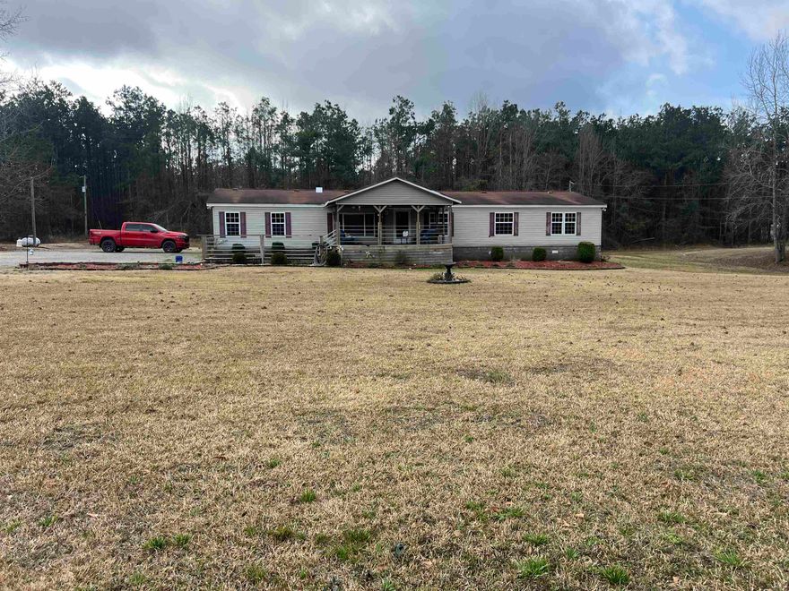 This charming 3-bedroom, 2-bath mobile home sits on a permanent foundation and is on three acres. It offers modern comfort with a spacious open floor plan. The kitchen features sleek granite countertops, a stainless steel refrigerator, and a propane gas range, perfect for cooking enthusiasts. Ample storage is available with large closets throughout the home. Step outside to enjoy the back deck, which overlooks a refreshing above-ground pool, ideal for relaxing or entertaining. A perfect blend of convenience and comfort! The property is in Cleveland County and has a Star City address.