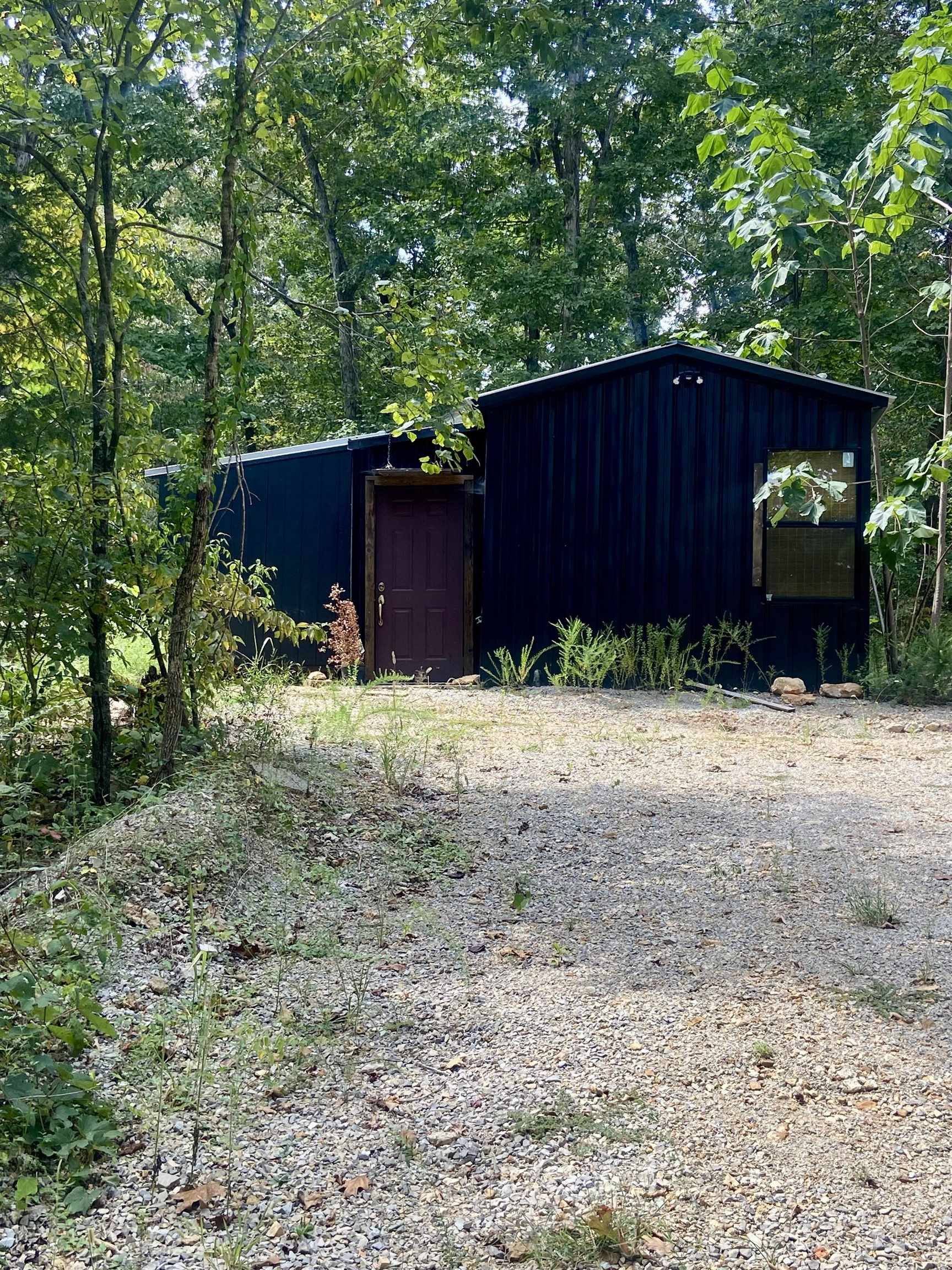 Flying on to the Market is 295 S. Summit Ridge Drive! Nestled in the Ozark Acres subdivision, this 1 bedroom cabin near the lake would make a perfect weekend getaway, full time home, or air bnb! One side of the home is finished and complete with an electric fireplace perfect for reading a book next to on cool nights.The other side is a blank canvas ready for you to add your own personal touches to. For the warm summer days, you are within walking distance to the lake. This home also features lots of outside space for watching nature, or having a summer picnic! This property has plumbing lines already ran to it and extra hookups perfect for adding a camper as well! This home won't last long so call today for your private tour!