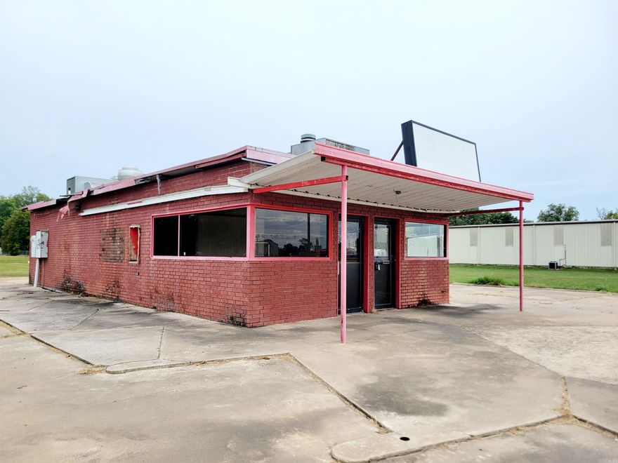 Commercial Property for Sale - Prime Location Across from Dardanelle High School This brick building offers a unique opportunity for a business looking to establish itself in a highly visible location. Positioned directly across from Dardanelle High School, the property sits on a large lot and includes a drive-through, making it ideal for a range of businesses such as a coffee shop, or fast-food establishment. The building is in need of repair, providing a great chance for customization to fit your specific needs.