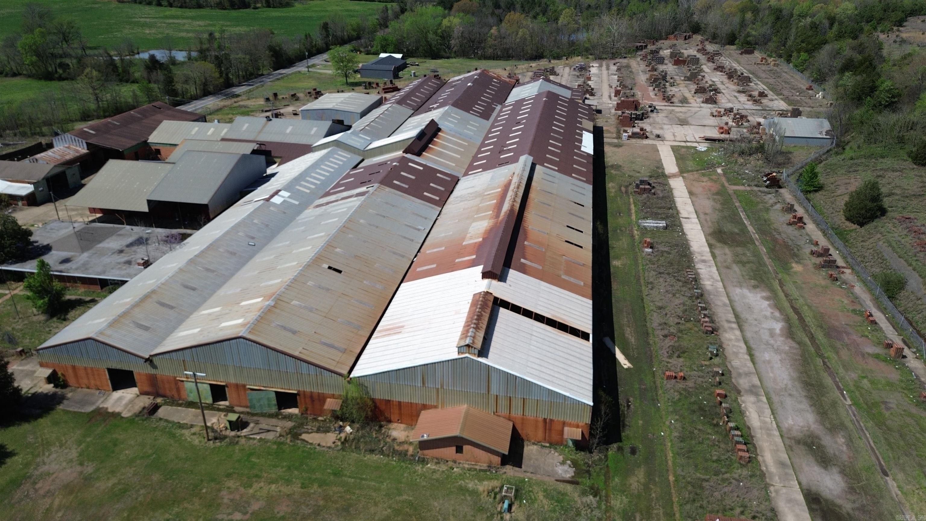 FORMER ACME BRICK MANUFACTURING FACILITY. 17 ACRES M/L INSIDE A CHAIN-LINK FENCE. MULTIPLE STEEL TRUSS BUILDINGS AND AN OFFICE WITH A BRICK EXTERIOR. MOST OF THE BRICK MANUFACTURING EQUIPMENT WAS REMOVED & SCRAPPED BY ACME PRIOR TO THE CURRENT OWNERS BUYING IT. GREAT VERY LEVEL PROPERTY WITH A LOT OF CONCRETE SURFACES FOR STORAGE & BIG TRUCK PARKING. APPROX 1/2 ACRE ASPHALT EMPLOYEE PARKING AREA FENCED IN ADJACENT TO THE PLANT FENCING. CAN BE MANY PUT TO DIFFERENT USES NOW INCLUDING TRUCK & EQUIPMENT PARKING, A LAY-DOWN YARD, WAREHOUSE SPACE AND MORE. EXCELLENT LOCATION OUT OF THE CITY LIMITS, BUT ADJACENT TO THE LAMAR CITY LIMITS. HWY FRONTAGE ON SOUTH & NORTH SIDES. ABOUT 3?4 OF A MILE FROM PROPOSED BILLION DOLLAR DATA CENTER LOCATION. SELLERS WILL CONSIDER SELLING OR LEASING ALL OR PART OF THE PROPERTY! CURRENTLY SELLING HUNDREDS OF THOUSANDS OF BRAND NEW BRICKS THE OWNERS ACQUIRED ALONG WITH THE REAL ESTATE!!!!!