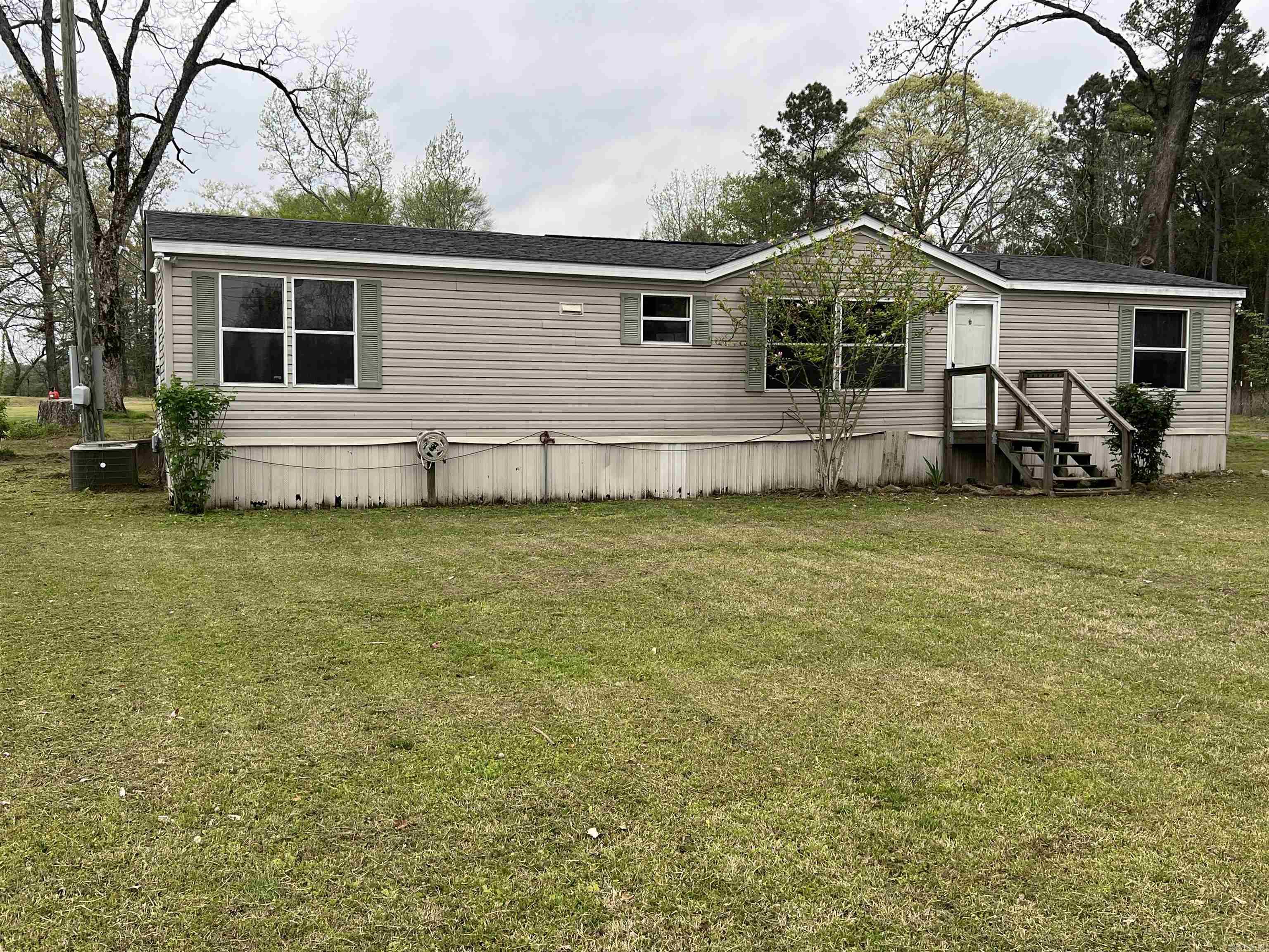 This property, located in a great area has a lot of possibilities. This 3 bed, 2 bath manufactured home has a split floor plan and a nice size living area. There are also two storage buildings located on the property. This home sits on 3 acres of land just outside of Benton. Call or text us to schedule your tour and see all of the potential of this home. Motivated Seller! Property is to be sold As Is.