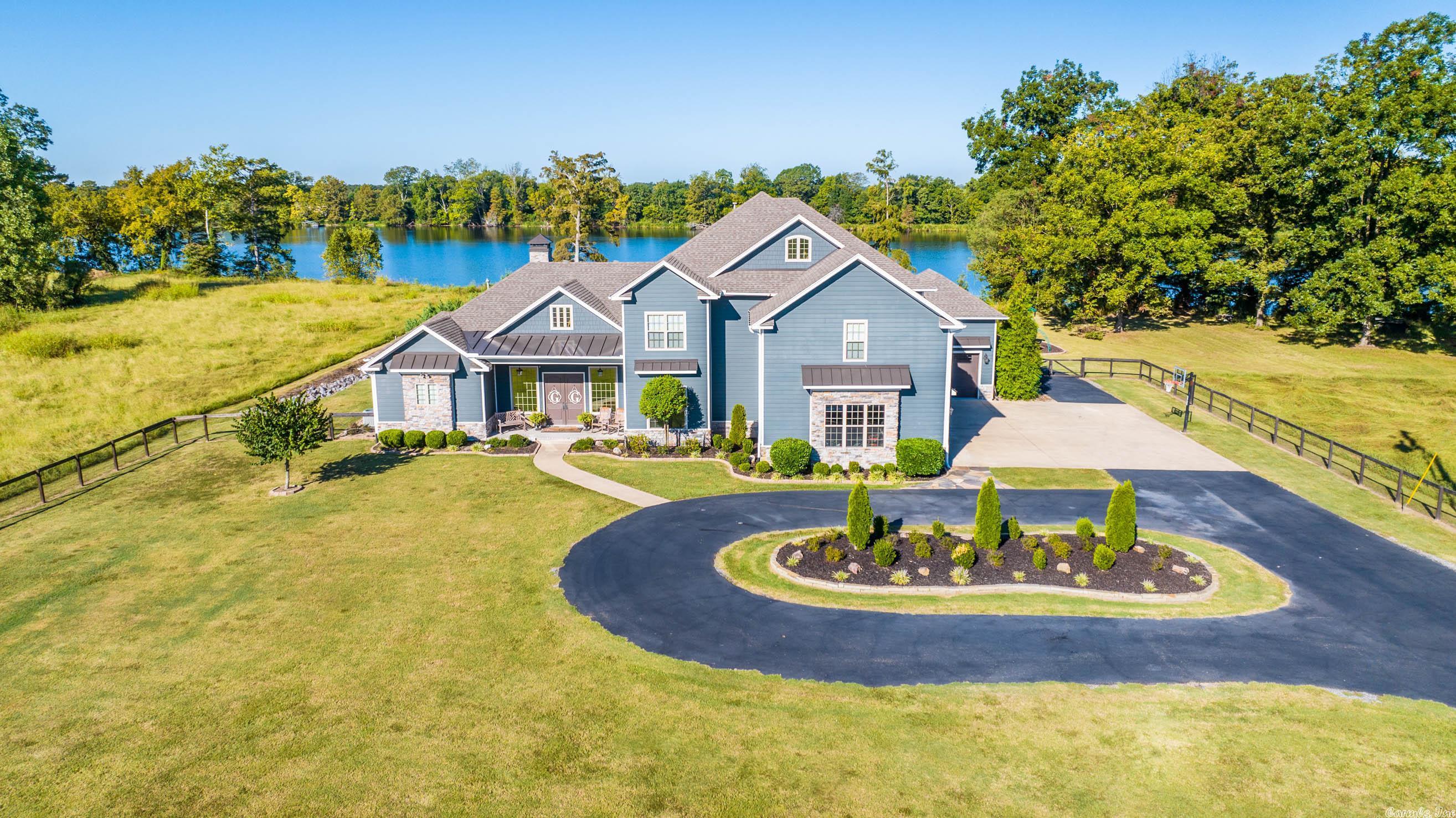 This property combines joy of lake life & upscale living w/ everyday lifestyle! Nestled behind a private gate sits an impeccable estate on 5 acres with 190 ft of lake frontage just minutes from Little Rock! Stately finishes of Italian Carrara marble, quartzite, granite, & 100 year old barn door are details felt throughout the home. Personal boat ramp w/ drive through boat garage are features hard to find. Sellers are eagerly anticipating their impending equestrian adventure, so schedule your showing today!