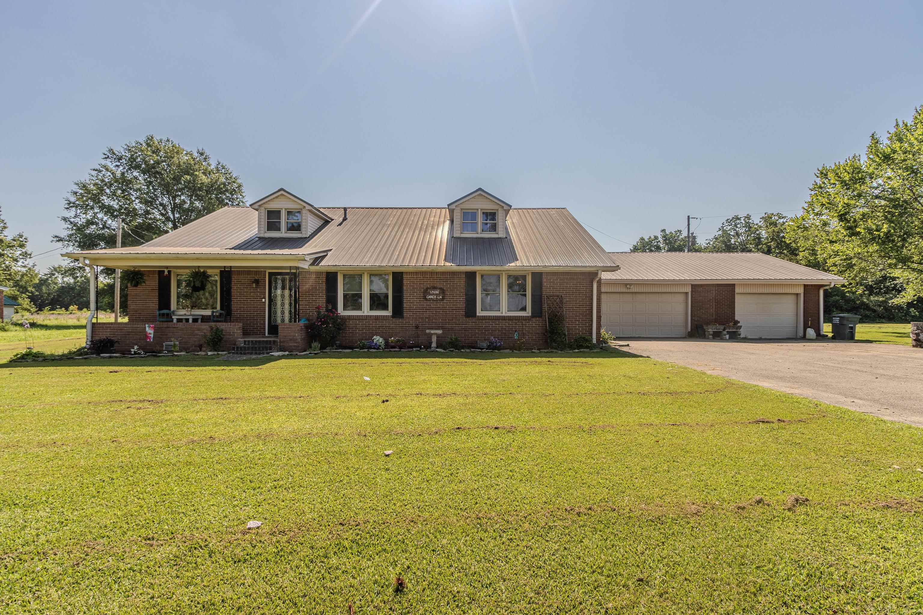 Your own slice of country paradise - if you want a large home on acreage with a peaceful setting and serene views, UNDER $250K, this is it! This home boasts 5 bedrooms, two full and one half bathrooms, and almost 3,000 sqft situated on +/- 1.5ac of level and manicured lawn. Upon front entry, you'll be welcomed into the large living room perfect for relaxing while taking in the abundance of natural light along with gorgeous countryside views. The kitchen is ready to serve up your favorite dish from stainless steel appliances, store family and friends' favorite snacks in the large walk-in pantry, and showcase your favorite keepsake dishware in the original dining room built-ins. The organic blend of original charm with modern amenities is hard to find, but this home executes it perfectly! No one would blame you if you got lost in the back den or sunroom for hours.. with both having their own gas log fireplaces and dreamy country views - who wouldn't want to spend countless hours in either spot?! Take your pick of the five large bedrooms, with the oversized primary suite and en suite on the main level, as well as two guest bedrooms on both floors.