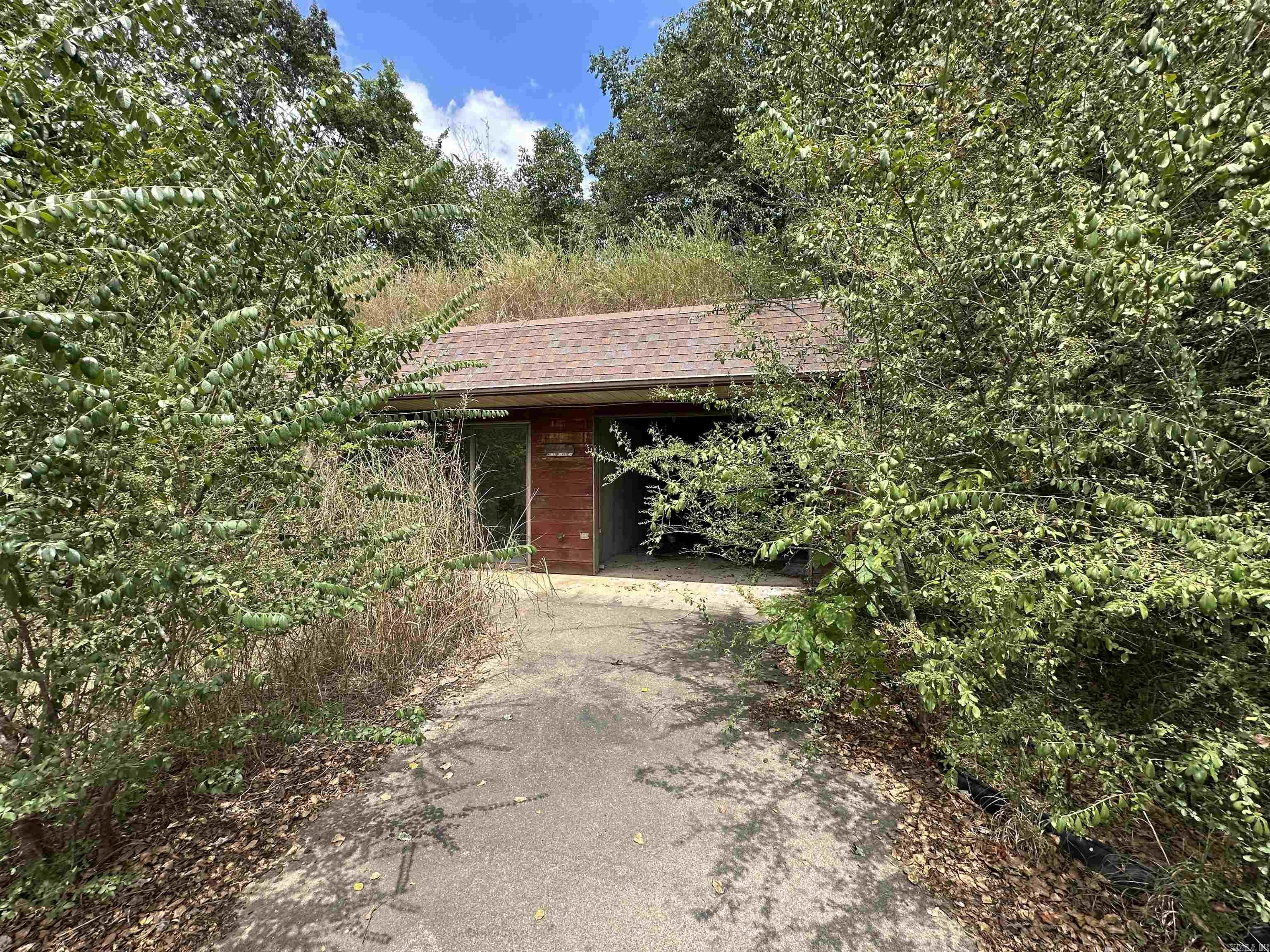 Looking for a project with potential near the White River? This unique property features an earth home with 2 bedrooms, 1 bath, and a dedicated laundry area. While the home is in need of TLC and repairs, it offers a great opportunity for someone looking to create their own retreat close to the river. The property also includes an old shop building that could be restored or repurposed to fit your needs. With a little vision and work, this could become a charming getaway, investment property, or full-time residence in a desirable location not far from the White River.