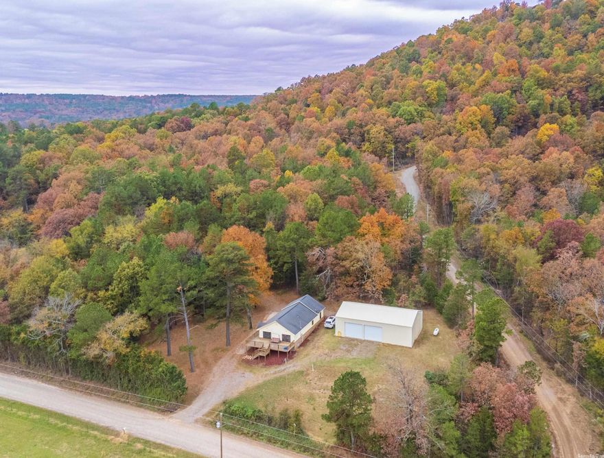 Almost 20 Acres! This 3 Bedroom home offers Amazing Views from your front porch! 30 X 50 SHOP! The insulated shop offers 12 ft ceilings, led lighting, 100 amp power, welder receptacle, & is plumbed for a restroom (Car lift included). The land runs behind the house and offer tons of wildlife and even includes a POND! Possible extra building site with Septic and water.