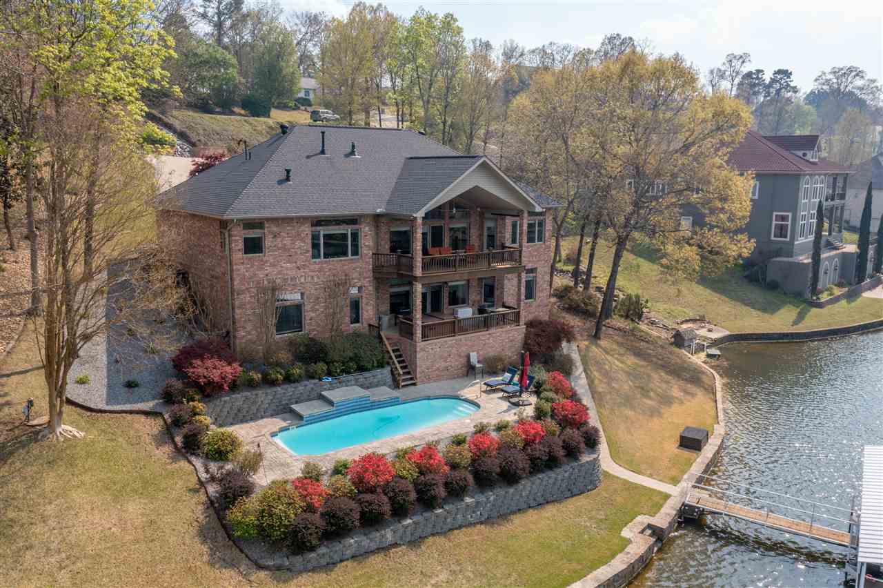 Must see this beautiful custom lake home located in the highly coveted Stonegate Shores Subdivision. The home sits on a 131' of lakefrontage and includes a two stall boat dock with a boat lift, an additional swim dock, in ground pool, a hot tub and tons of outdoorentertaining areas. The interior boasts an open kitchen/living combo, larger master en suite, multiple living areas, three bedrooms on themain level, and much more. Well constructed home with 2x6 walls and all Anderson Windows/Doors.