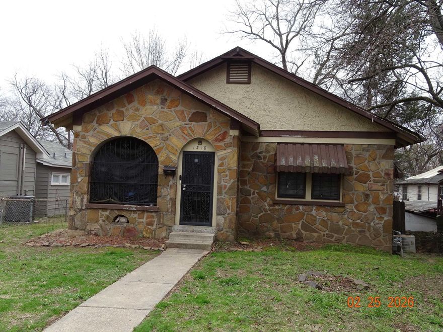 Check out this cute home.  It has enclosed front porch.  It has a fenced yard and a 1 car carport.  There is a second dwelling in the back yard.  This structure needs work.  There are broken windows and the floor needs work. Sold as is