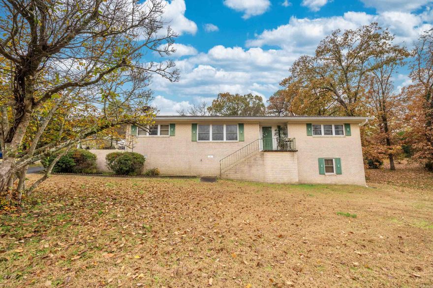 This charming 3-bedroom, 1.5-bath home is a gem in the highly sought-after neighborhood of Hot Springs. Situated on a generous .68 acre corner lot, this property offers both space and privacy. Only a few minutes to Hot Springs Country Club, National Park Hospital, many restaurants and the by-pass, this home is in the perfect location. Recent updates include a new HVAC system in 2023 and a new roof and gutters in 2022. Additionally, a full-house generator provides peace of mind during power outages, keeping you comfortable in any situation. The backyard is fully fenced for your kids or pets.  One of the highlights of this home is the covered back deck, perfect for outdoor gatherings. The basement storage area offers convenient access from both inside and out, providing ample space for all your belongings. Part of this space is heated and cooled for a possible extra living space. The kitchen is a modern delight, complete with a breakfast bar that's perfect for quick meals and entertaining.   A large master suite has hardwood floors and one of the bedrooms is walled with finished knotty pine.  Not a small bedroom in the house.