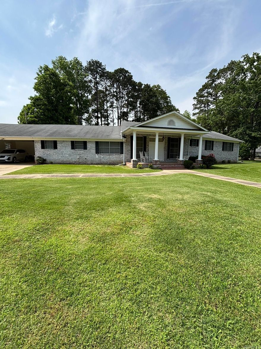 One owner traditional custom built home.  3 bedroom, 3 bath home.   Rooms are large and spacious.   Den area with fireplace and built in cabinets. Formal living room with tall ceilings.  Floors are hardwood, carpet and vinyl.  Large master bedroom with walk in closet in the master bath.  2 car garage with large carport storage.   Central heat and air, also has a Kohler generator.  All appliances included, and most of the furniture will stay with home.   The home is brick with siding trim.