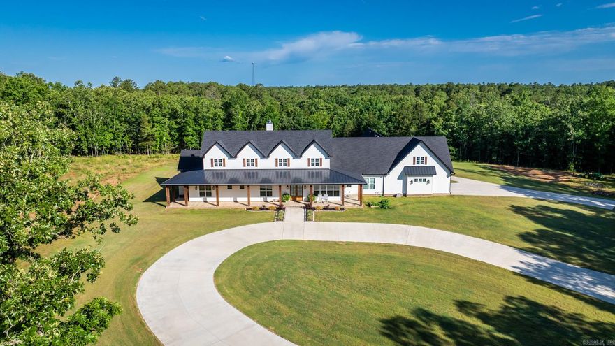 Where Privacy Meets Grandeur- A Rare 40 Acre French County Estate That Redefines Luxury Living. A private drive leads to this stunning French Country Ranch Estate with an unmatched blend of elegance and warmth, across 40 breathtaking acres, complete with a small pond and beautiful wooded views. The wrap-around porch sets the tone for the craftsmanship found throughout, including soaring vaulted ceilings with wood beams, a floor to ceiling stone-accented wood-burning fireplace, rich herringbone brick flooring, and quartzite stone countertops at every turn! The chefs kitchen is a showpiece featuring a professional-grade range, stone backsplash, custom cabinetry, and a fully appointed butlers pantry with wall oven, a second refrigerator, and storage galore. The luxury primary suite is your own private retreat featuring a fireplace, panoramic views of the grounds, dual master closets, and a screened porch of its own with direct access to the resort style gunite pool and spa. The primary bath offers dual toilet rooms, an oversized tile shower, and bespoke finishes. Other Features: 3 bedrooms include their own en suite baths, 2 offices, home gym, safe room, generator & so much more!