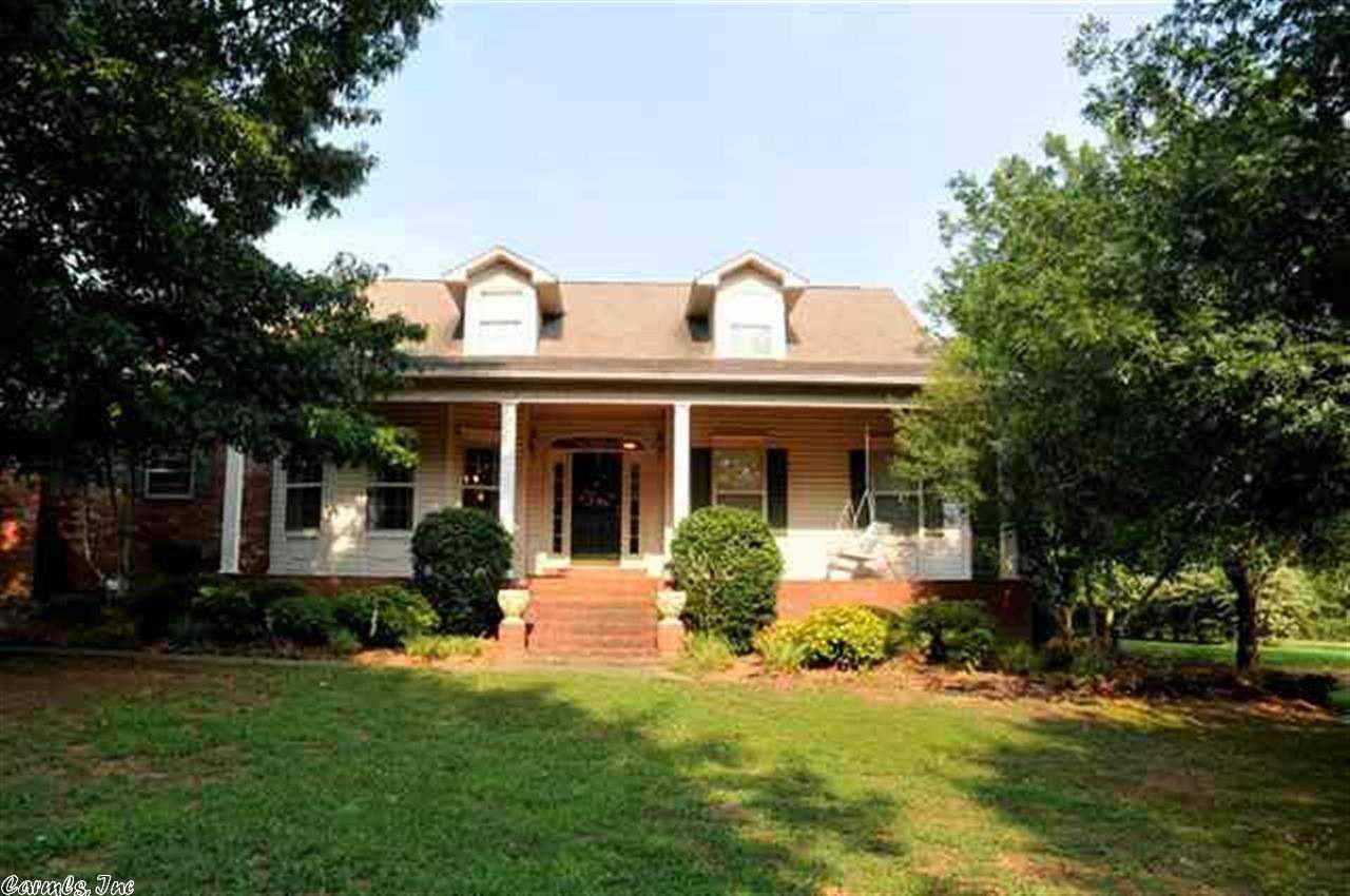 Large home in Country Club Area on secluded street. 3BR/3BA with Bonus Room that could be a 4th bedroom. Sunroom off Master adjoins Living Room. Huge Dining room can accommodate most any family sized table. Kitchen is large with loads of cabinets. 3rd bathroom is located off laundry room and has shower. Porches on front and back have brick floors. Big storage room in garage also has double doors to the back to bring mower in. Over 1 acre, lots of home and land for the money.