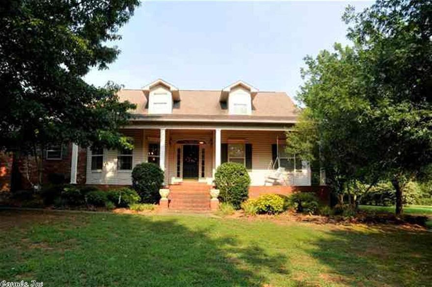Large home in Country Club Area on secluded street. 3BR/3BA with Bonus Room that could be a 4th bedroom.  Sunroom off Master adjoins Living Room.  Huge Dining room can accommodate most any family sized table. Kitchen is large with loads of cabinets.  3rd bathroom is located off laundry room and has shower.  Porches on front and back have brick floors.  Big storage room in garage also has double doors to the back to bring mower in.  Over 1 acre, lots of home and land for the money.