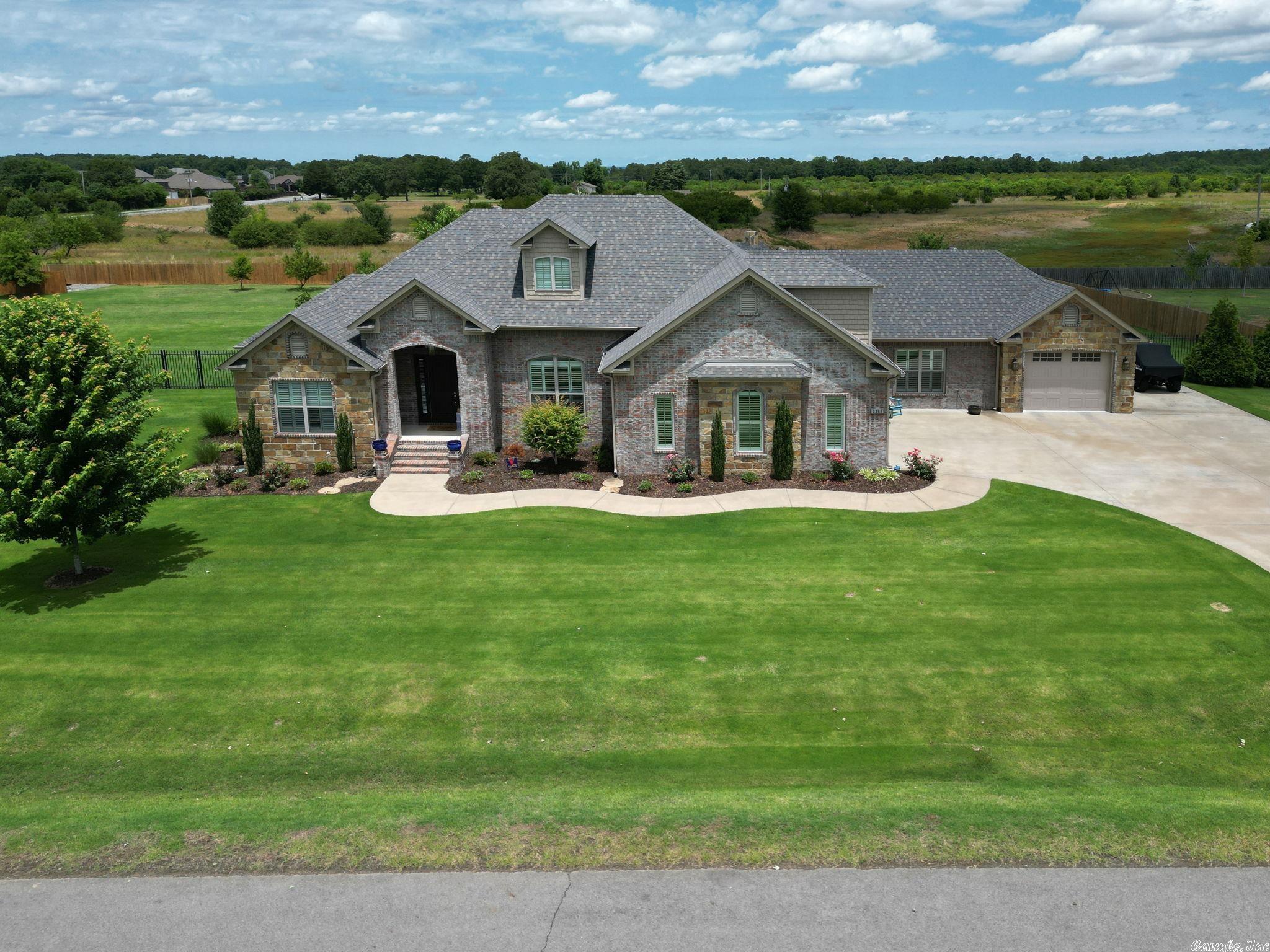 Unveiling 2360 Springcrest St., Conway - a 4BR/3BA oasis on 1.33 acres. Boasting a 3-car garage with custom cabinets, finished floors, and an enviable custom pool. The kitchen shines with Cambria quartz countertops and a walk-in pantry. Indulge in comfort with hardwood floors, plush carpet in two bedrooms, and a bonus room. Stay organized with dual walk-in closets, a spacious laundry room, and a bonus room upstairs. Relax outdoors on a covered porch, complete with a TV, overlooking a fully fenced, irrigated yard. New roof in 2022.  Luxurious living awaits! This truly is one of a kind, a must see!
