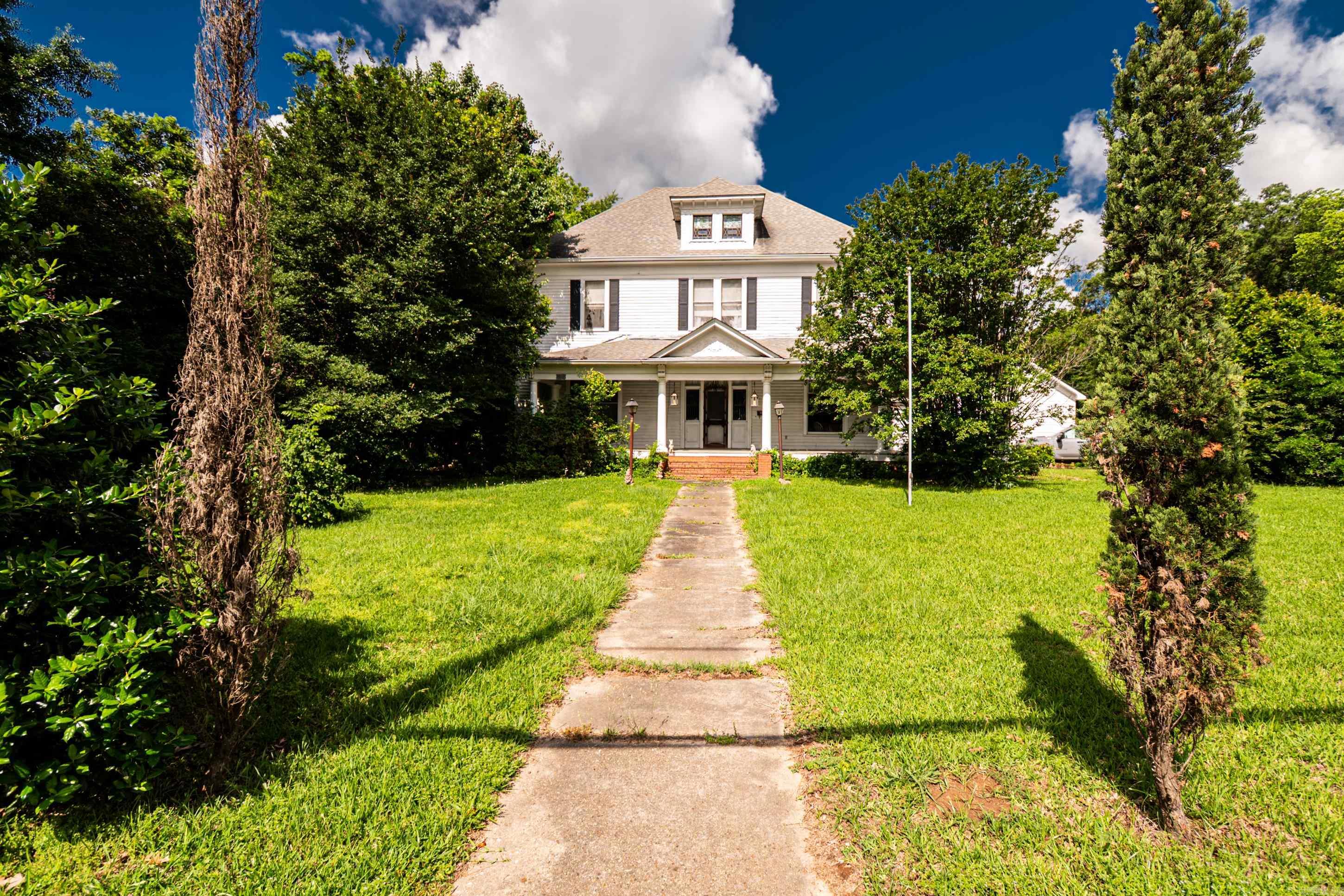 This beautiful piece of history in Monticello Ar is a masterpiece. With 4348 sq feet of heated and cooled living area, you will not run out of room. The home has a very spacious 3 bedrooms, 2 bath rooms, multiple sitting rooms, a formal dining room and much more. The house feature tall ceilings and 4 fireplaces, yes 4 fireplaces. Being built in the year of 1900 this makes it one of, if not the oldest homes in Monticello that is still standing and full of history. With only one family owning this property until the current owner, there is much of this home that has been preserved to stay original. Enjoy the backyard, gazebo, and the old cabin that is tucked away right in the middle of town. This home would be perfect form somebody who truly enjoys history, older homes, or could make a very special getaway/short term rental. Call today to schedule a tour.