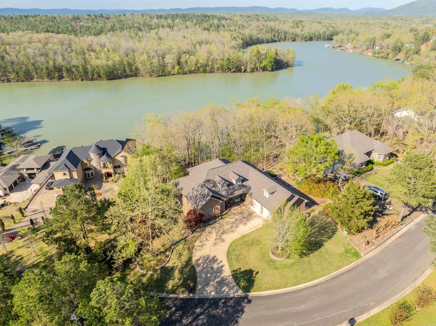 Welcome to your slice of paradise on Lake Hamilton! This stunning 3,437 sq. ft. home is the ultimate retreat, offering luxurious living and breathtaking views. With three spacious bedrooms and three baths, this home is designed for comfort and style.  As you enter, you'll be greeted by an inviting layout that includes a dedicated office, a separate dining room, and a sunroom perfect for soaking up the natural light. The chef's kitchen features all stainless steel appliances, making meal prep a joy! The primary bedroom with ensuite bathroom as well as guest bedroom and bathroom are located on the main level.   The downstairs living quarters provide a fantastic opportunity for guests or family, complete with one bedroom, one bath, living room, a full kitchen, and its own entrance and garage. This bedroom also is a safe room. With an oversized garage, you'll have plenty of room for vehicles, toys, and storage.   Step outside to your private oasis on the covered back porch, where you can unwind by the sparkling saltwater pool or enjoy lake life from your two-stall covered dock, complete with a swim platform. New roof 2023.