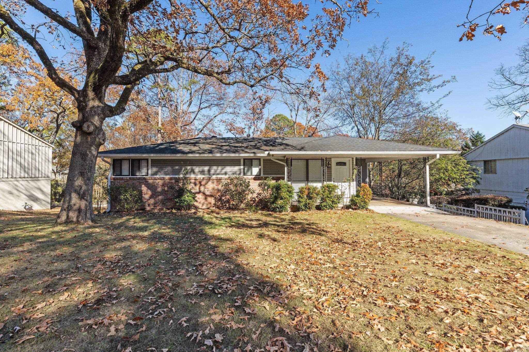 Welcome to 14 Brookridge Drive, Little Rock, AR 72205! This beautifully updated 5-bedroom, 2.5-bath home offers 1,788 square feet of thoughtfully designed living space. The split-to-the-rear layout provides versatile functionality with two spacious living areas, perfect for entertaining or family relaxation.  The open-concept main living and dining area features gleaming hardwood floors, crown molding, and ample natural light. The modern kitchen boasts granite countertops, stainless steel appliances, and plenty of cabinetry. Five well-sized bedrooms offer flexibility for home offices or guest spaces, while the primary suite includes an en-suite half-bath for added privacy.  Downstairs, you'll find a second living area with wood-look tile flooring and a cozy exposed brick accent wall, adding charm and character. The home's two full bathrooms are tastefully updated with contemporary fixtures and tile work. A dedicated laundry room with built-in cabinetry ensures convenience.  Outside, the fenced backyard with mature trees provides space for outdoor activities or quiet retreats. Schedule your private tour today and make this gem yours!