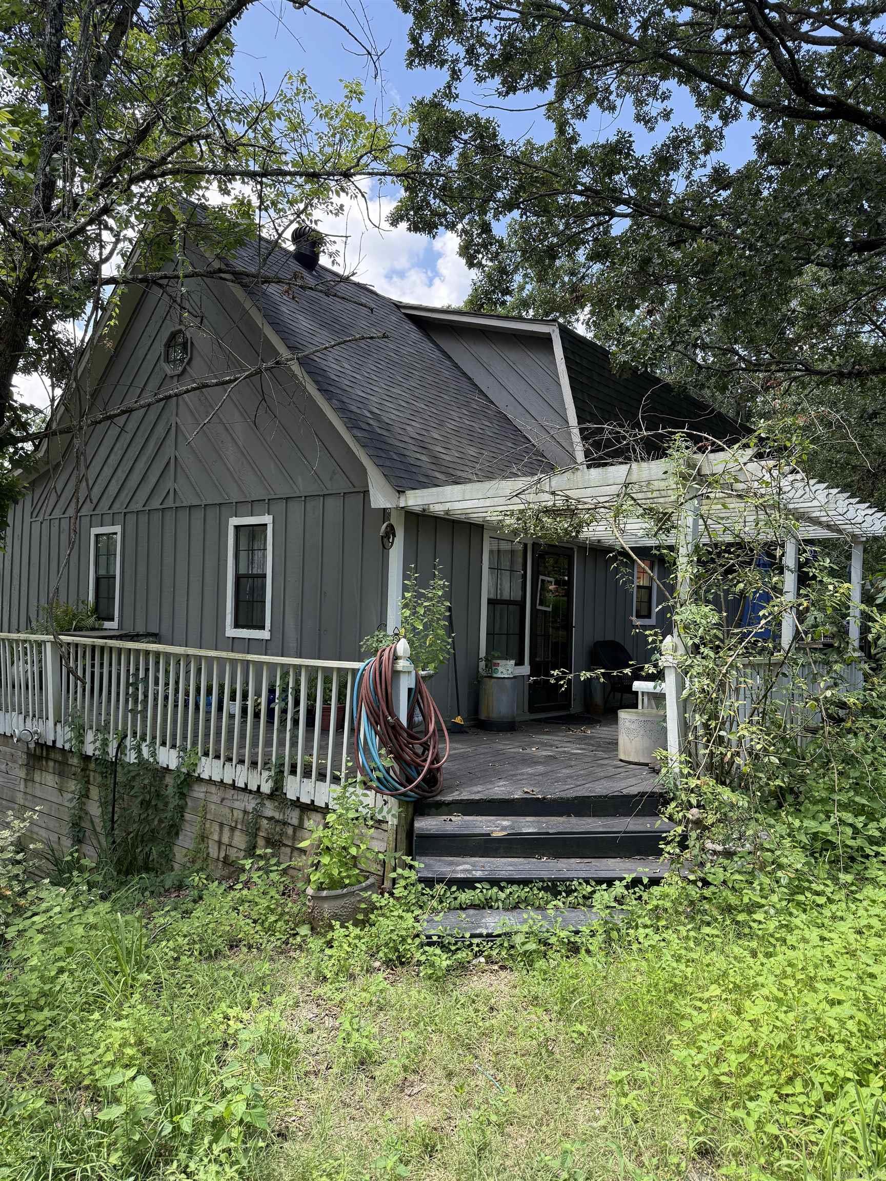 Priced to SELL FAST!! Formerly listed at $410,000.00. Very Secluded 4 Bdr, 4 Bath home, tri level with 2000 sq feet decking all around home. This 3200 Sq Ft home sits on 2.47 acres with privacy gate. Has pine wood flooring throughout. Kitchen has stainless steel appliances with double ovens, gas stove top, dishwasher with a breakfast bar, and pantry. Has a large screened in porch with hot tub and a large laundry room. Master Bedroom is on main floor with a mst. bath and walk in closet. Upstairs has a built-in bookcase and is perfect for an office. Has 3 Bdrs upstairs. This home has lots of space and storage. Lots of fruit trees in yard. Large 30x40 metal shop with electricity. Seller will not make any repairs. Sold as is. Better pictures are coming soon. Please see Agent Remarks for all showings.