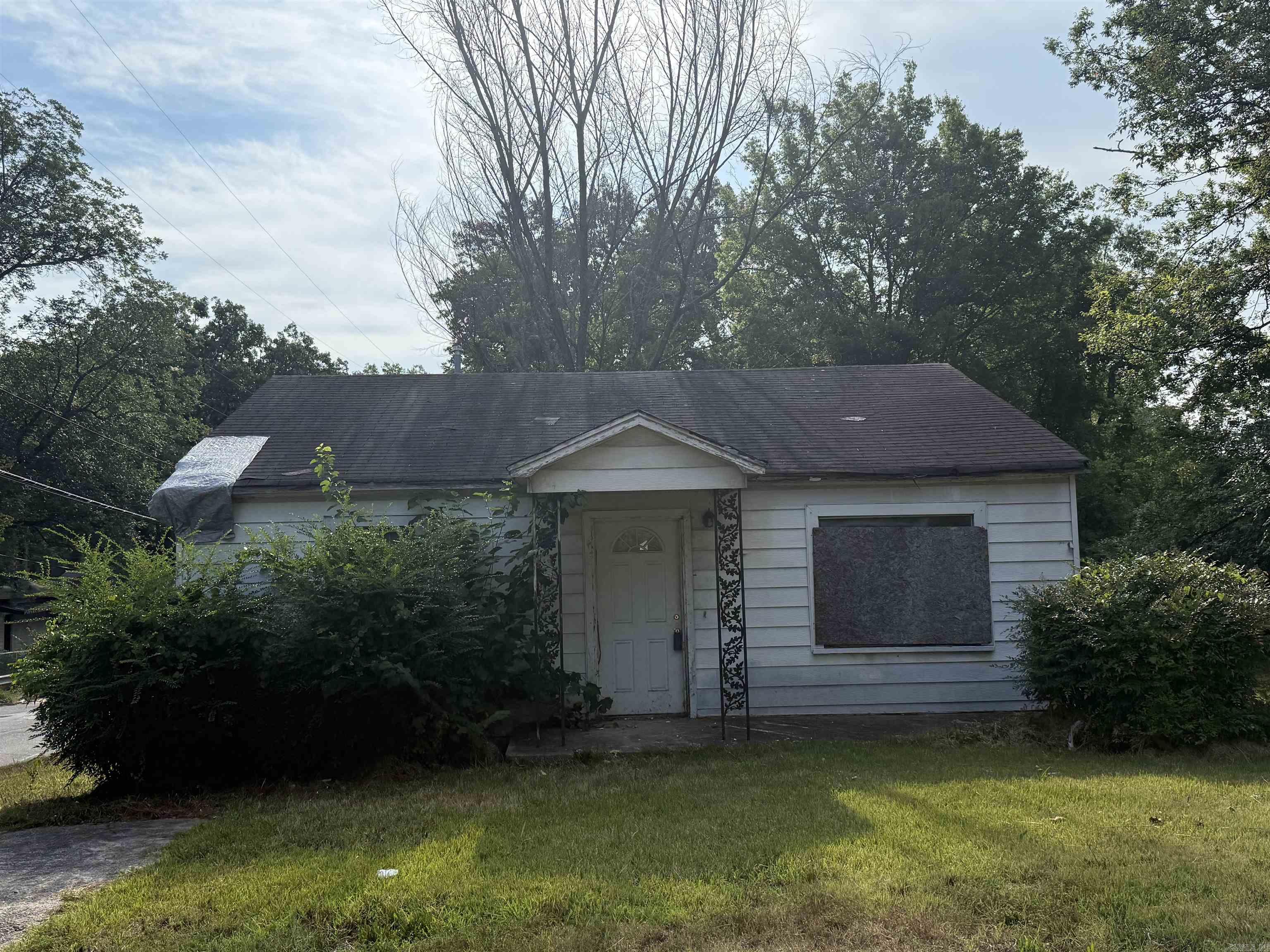 This two-bedroom home offers a fantastic opportunity for a skilled contractor or handyman seeking a rewarding project. Situated on a desirable corner lot, it boasts original hardwood floors, just waiting to be brought back to their former glory. While requiring extensive rehabilitation, the layout presents a blank canvas to create significant value through thoughtful renovations. Bring your vision and expertise to this promising investment. Hold Harmless Form must be signed before entering. See associated documents.