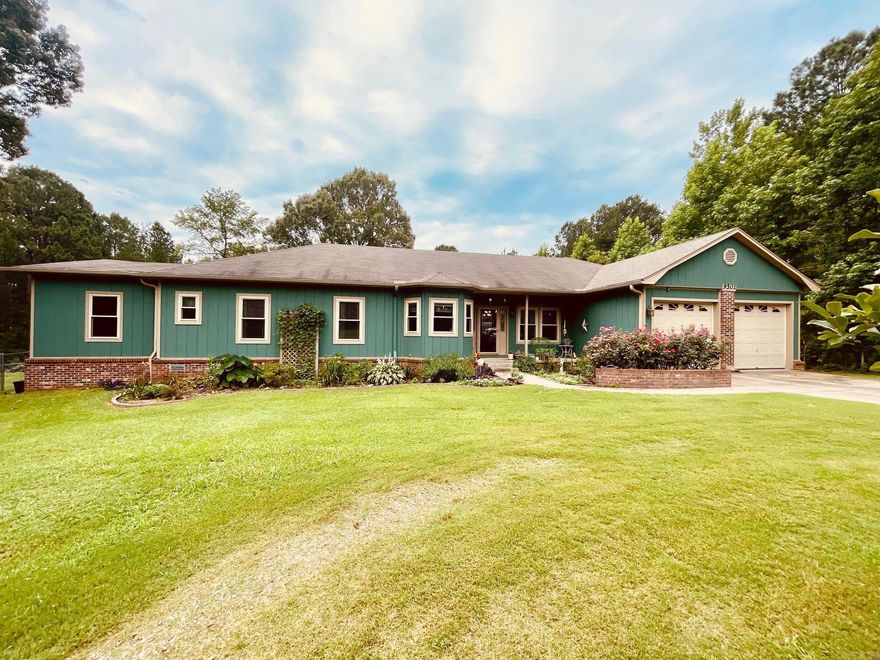 Charming home nestled on a 4-acre flat, wooded property. This ready-to-move-in home offers an open concept connecting the Living Room, Dining Room, office, and Kitchen. The Kitchen includes a gas range, dishwasher, refrigerator, stained cabinetry, tile countertops, and a movable island. The Primary Suite boasts double closets, an updated bath with a large tile shower, and a vintage cabinet with a raised sink. Additional bedrooms share a full bath, with one currently serving as an extra family room. A Laundry Room is conveniently located near bedrooms. The delightful Sunroom off the kitchen is filled with sunlight from numerous windows and has a separate mini-split for heating and cooling. A Deck provides views of the natural greenspace and fenced backyard. Enjoy new windows, a deck with a pergola, a garden area, fruit trees in the front and backyard, and a storage building with a concrete floor. Enjoy the peaceful country setting with deer sightings, while having easy access to I-30 & I-430. See Confidential Remarks for more details.